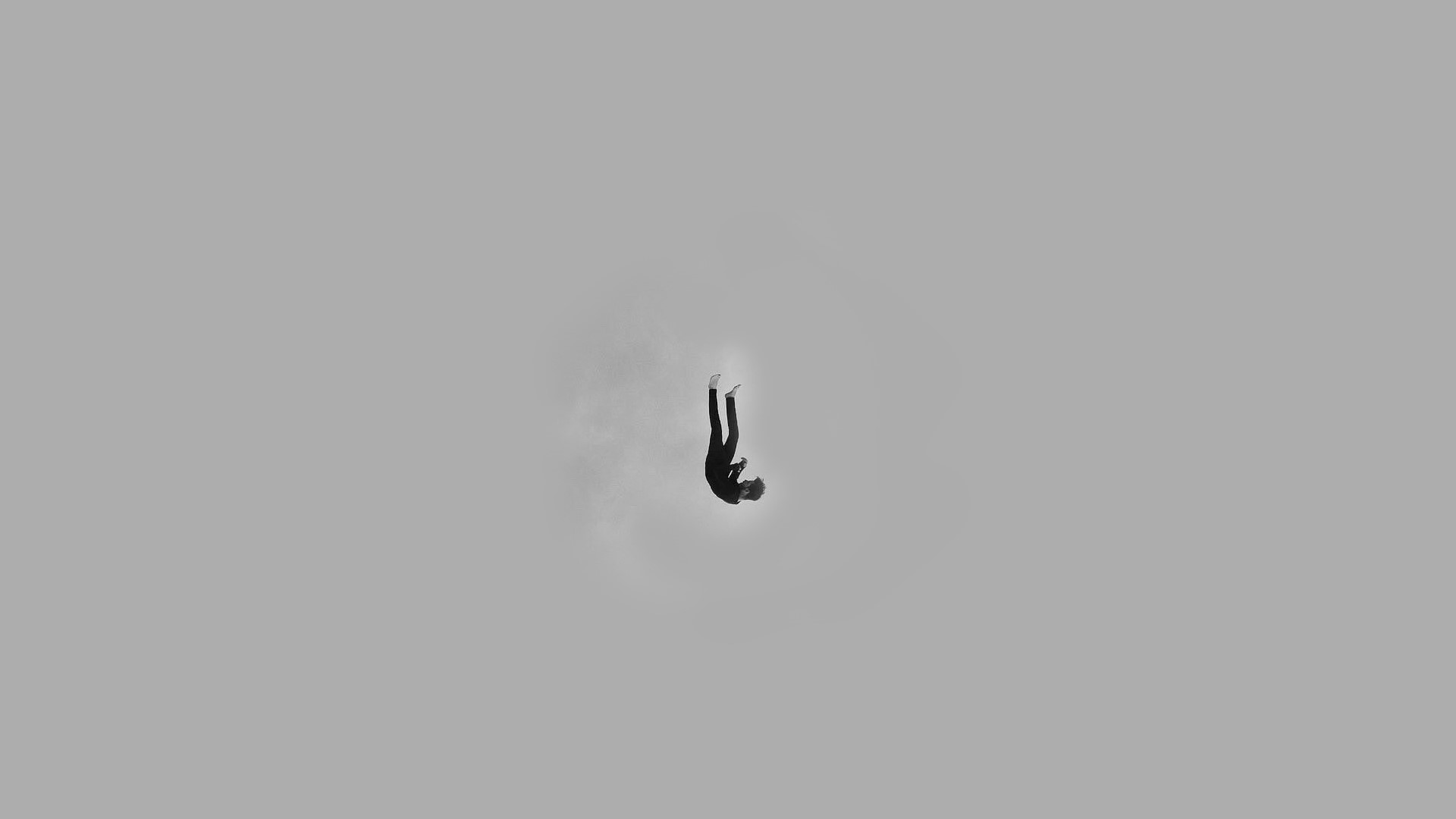 Person falling in a minimalist grey sky HD Wallpaper