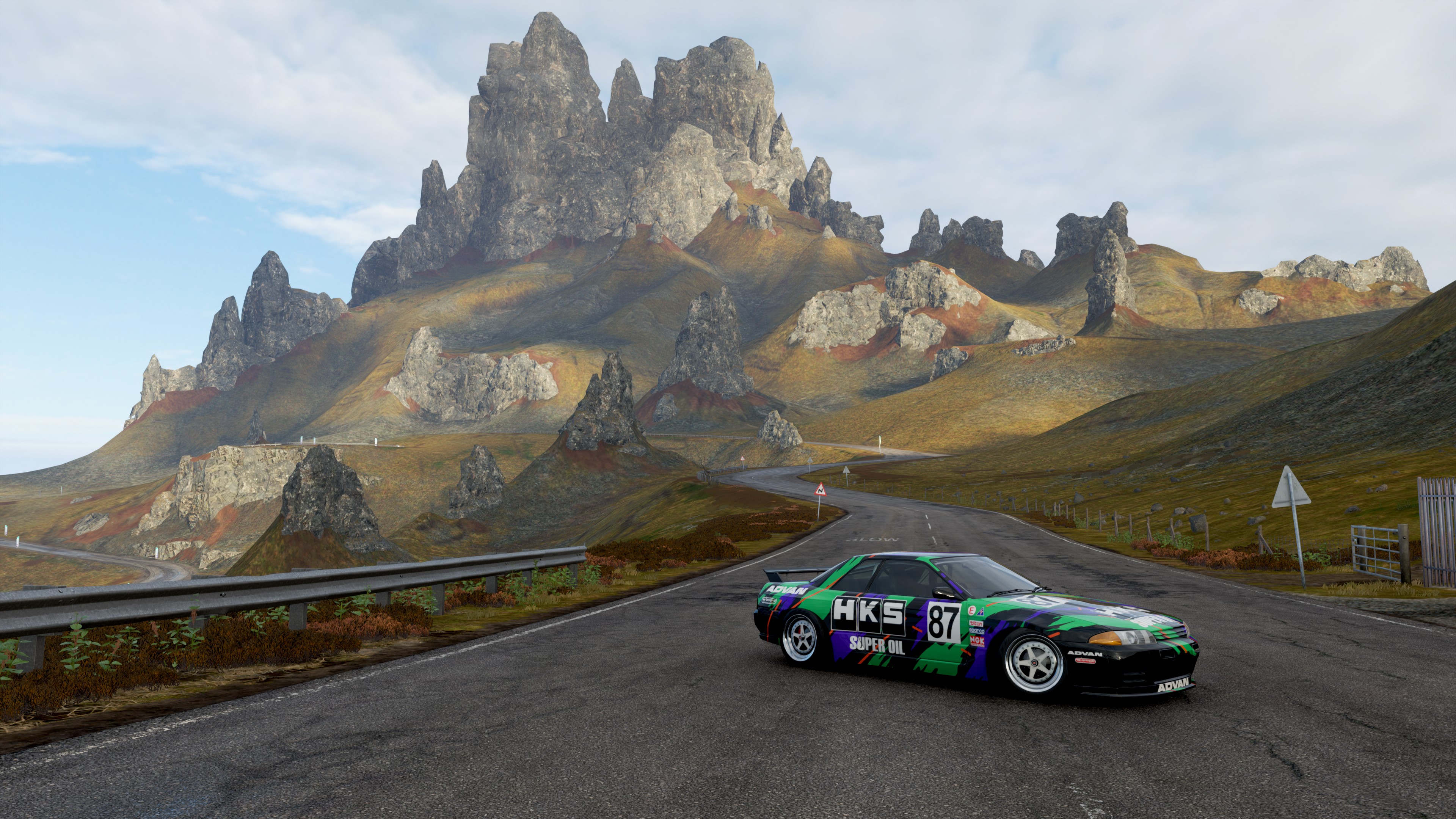 Nissan Skyline R32 HKS car on a road with mountains HD Wallpaper