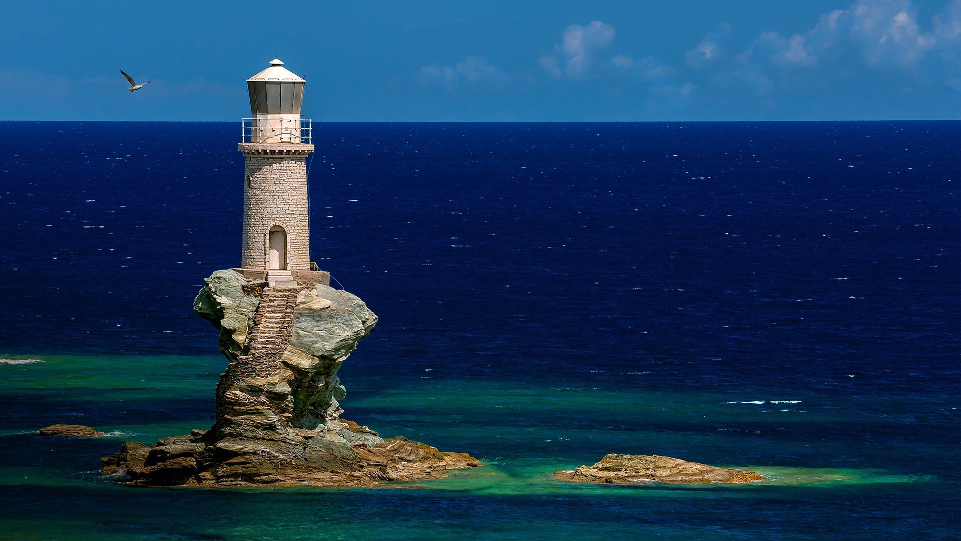Faro Tourlitis lighthouse on a rock in the sea, Greece HD Wallpaper