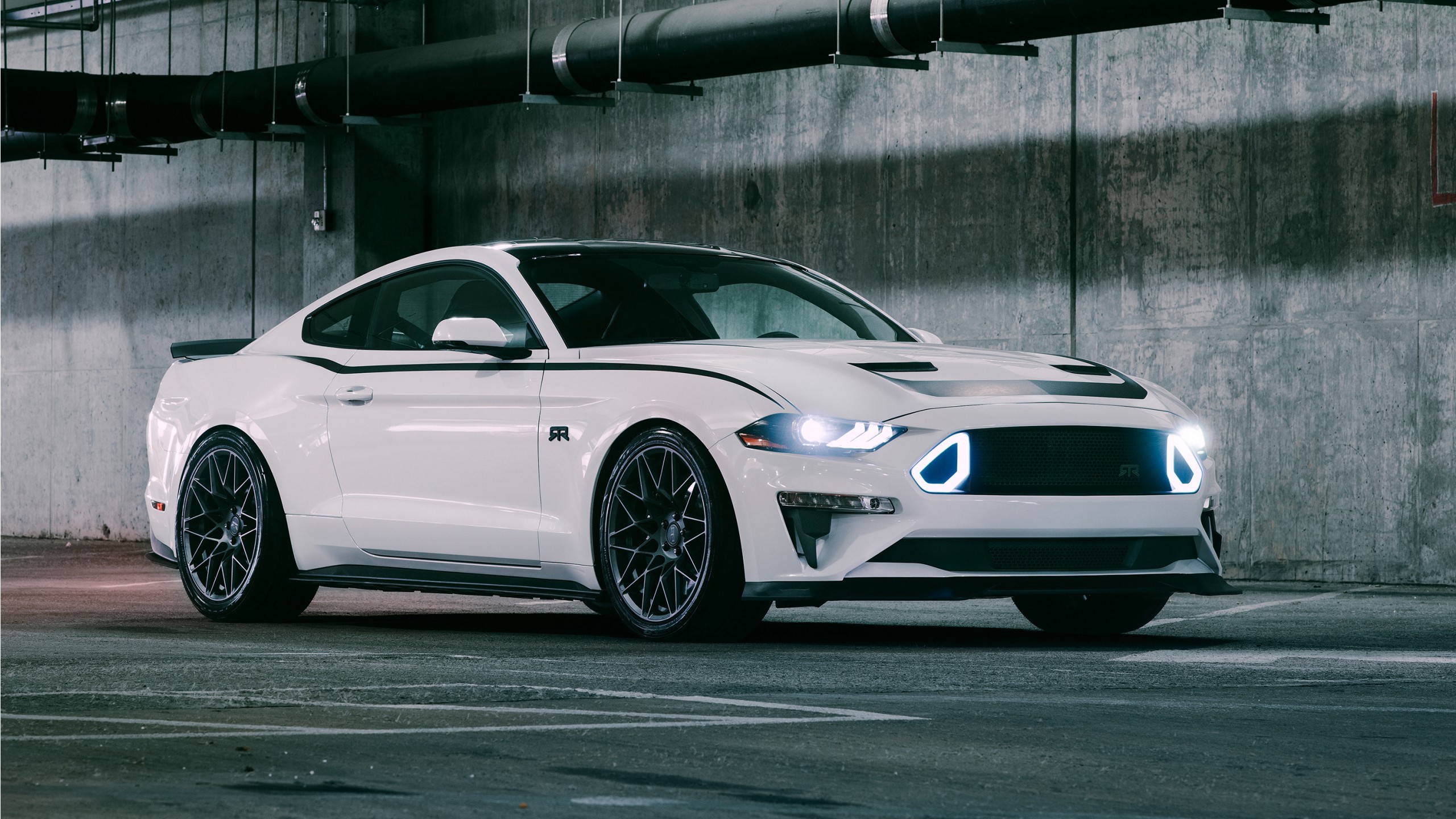 White Ford Mustang parked in a concrete parking garage HD Wallpaper