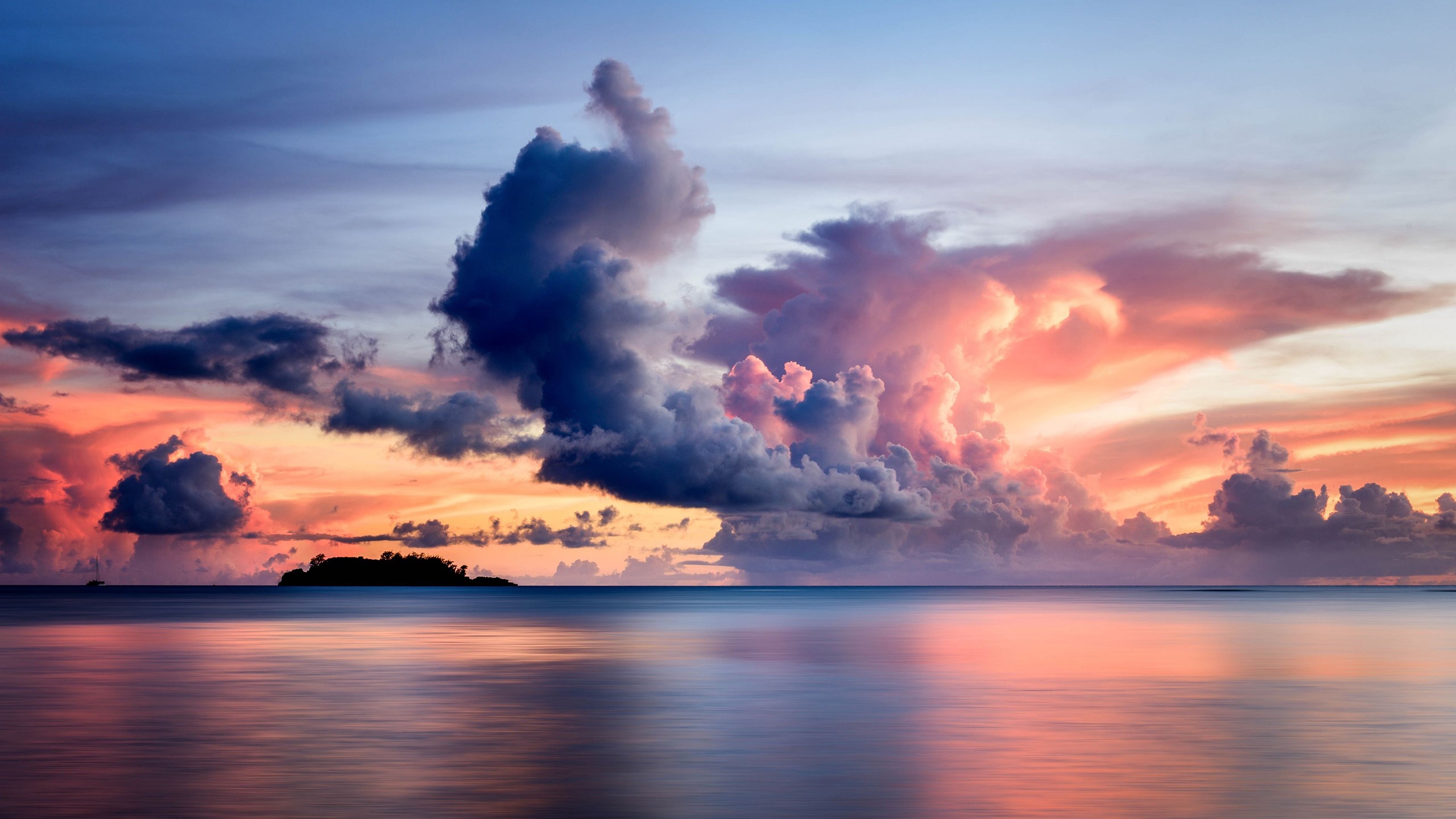 Dramatic sunset over the ocean with island silhouette HD Wallpaper