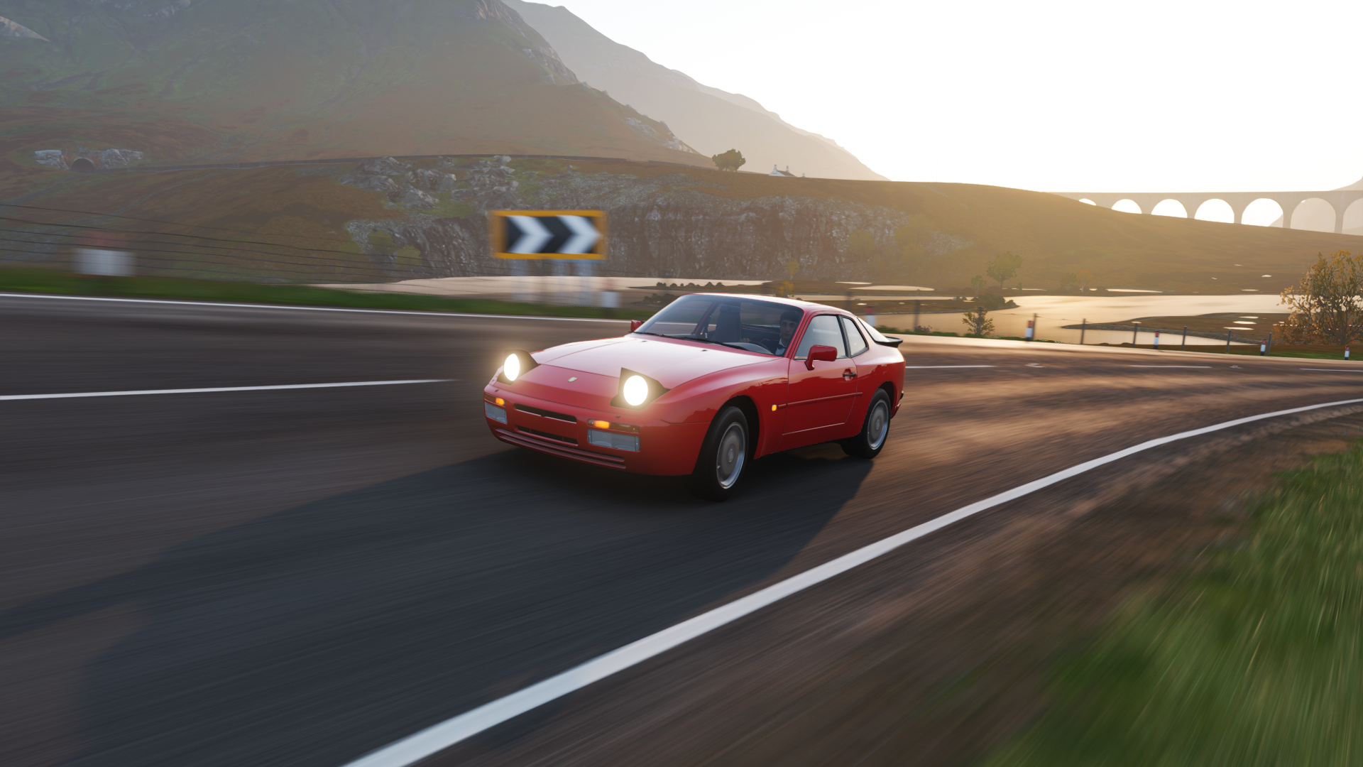 Red Porsche 944 driving on a road in Forza Horizon 4 HD Wallpaper