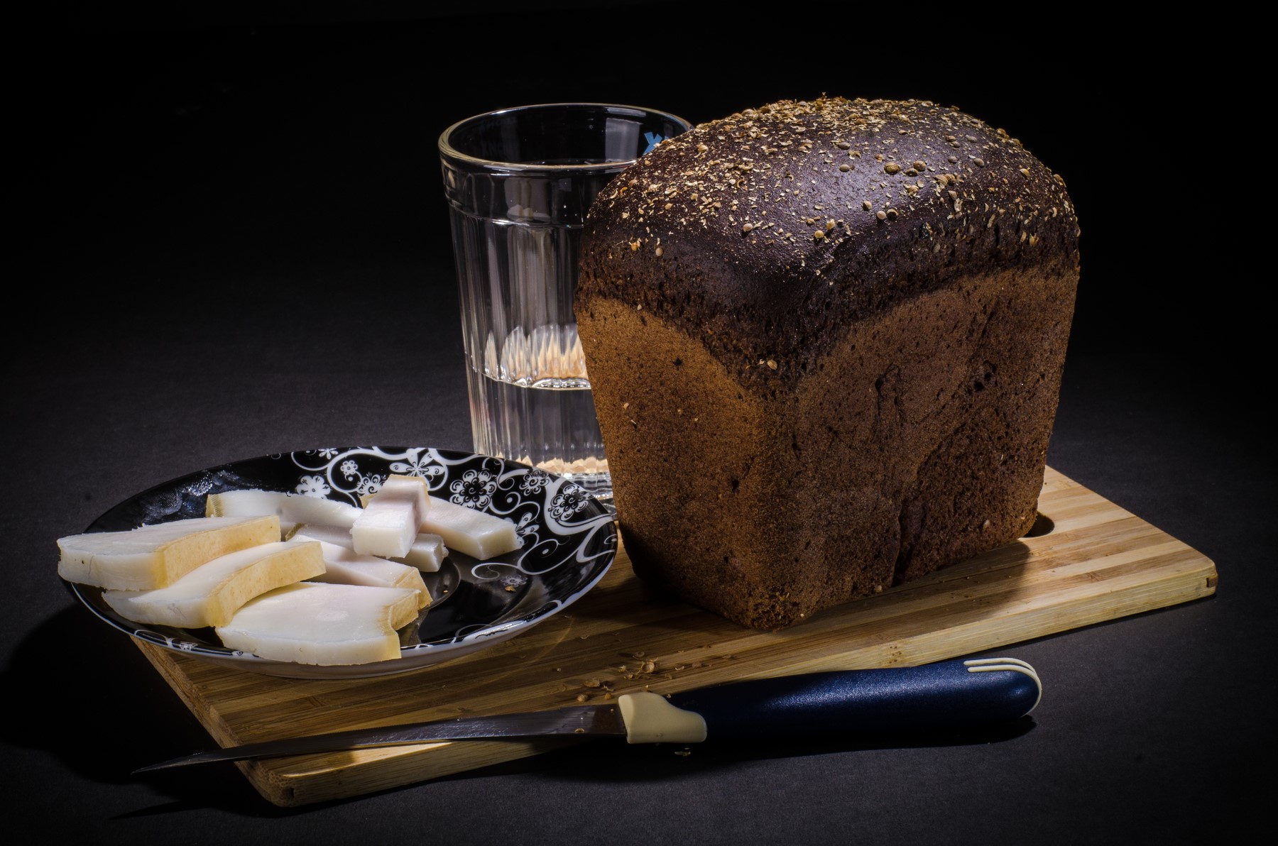 Bread, bacon, water, and knife on cutting board HD Wallpaper