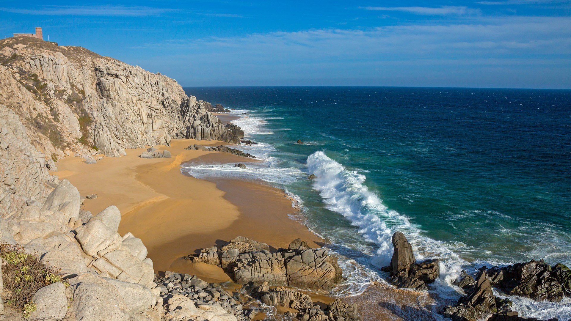 Rocky coast with a sandy beach and waves in the Pacific Ocean, Mexico HD Wallpaper