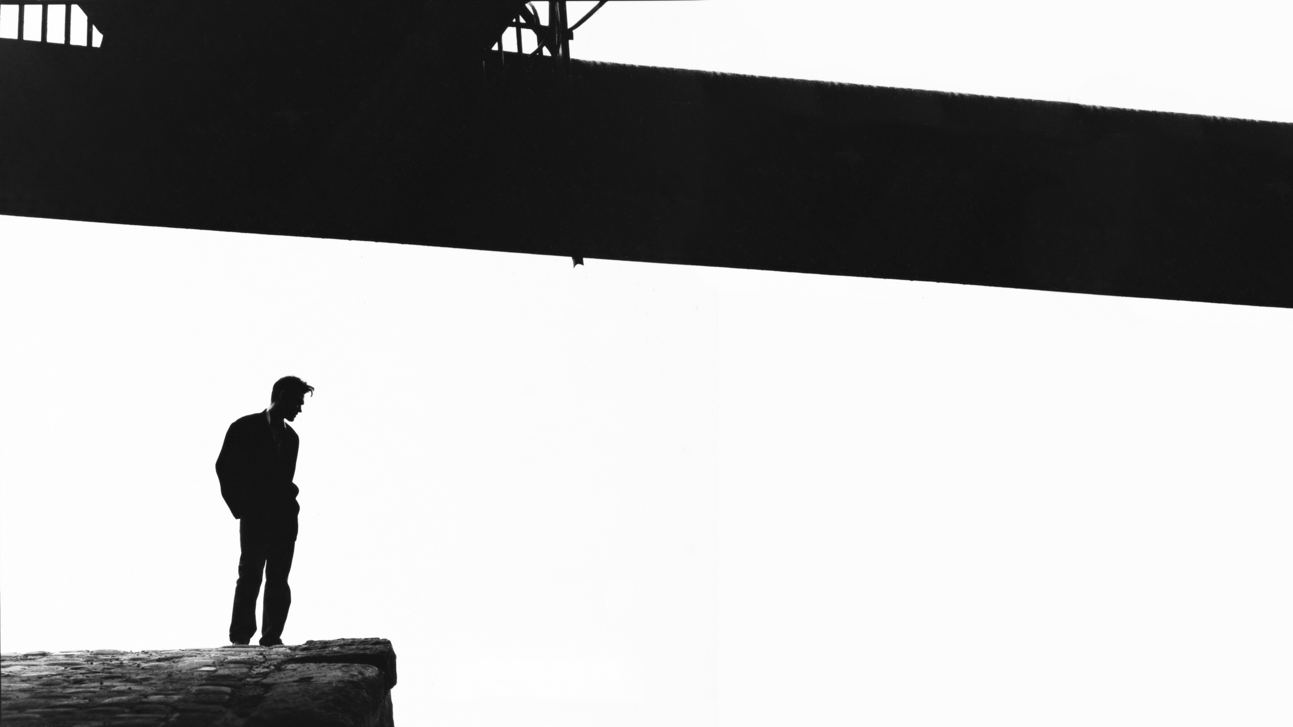 Morrissey standing on a cliff under a bridge HD Wallpaper