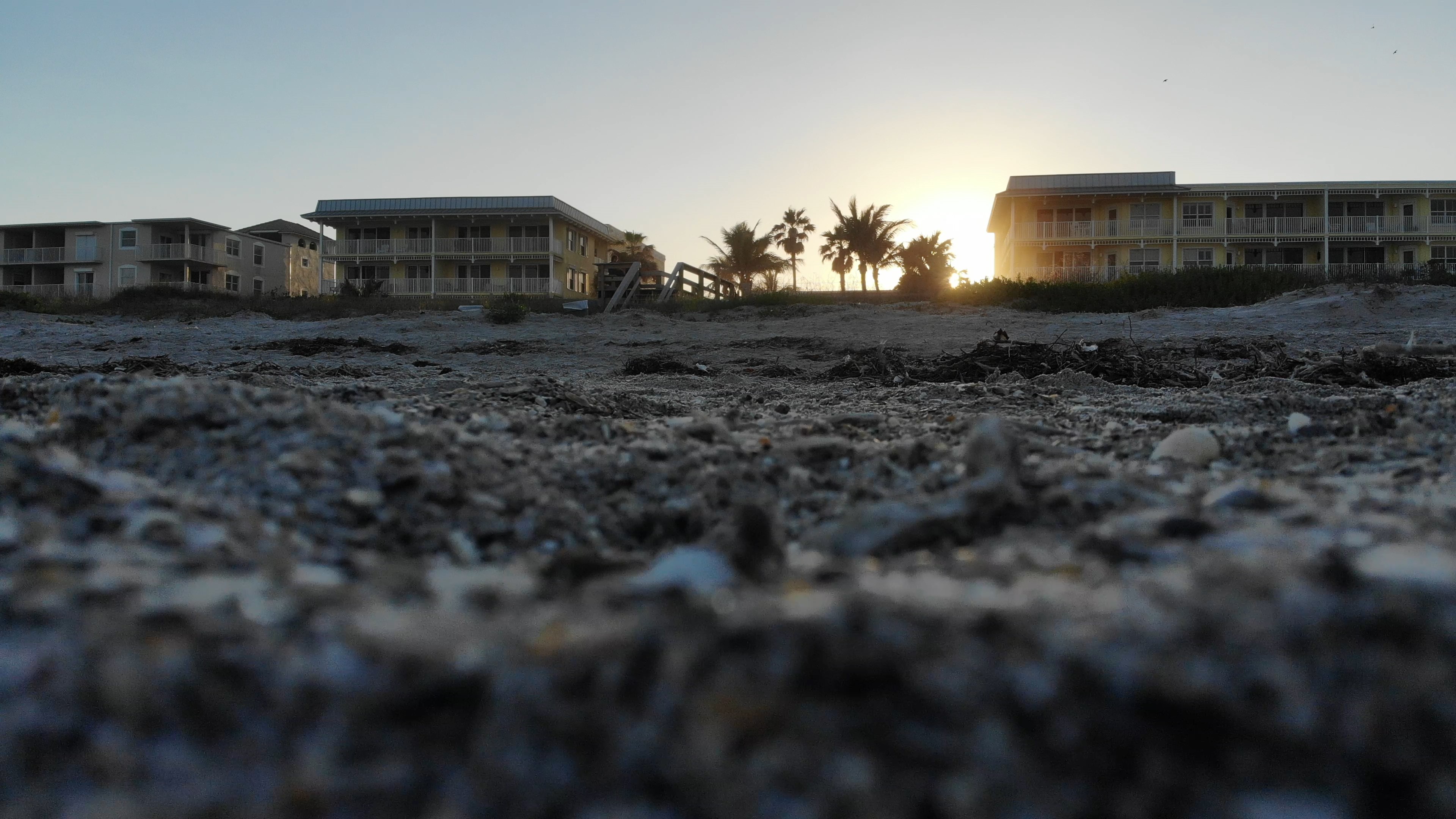 Worm's eye view of beach buildings at sunset HD Wallpaper