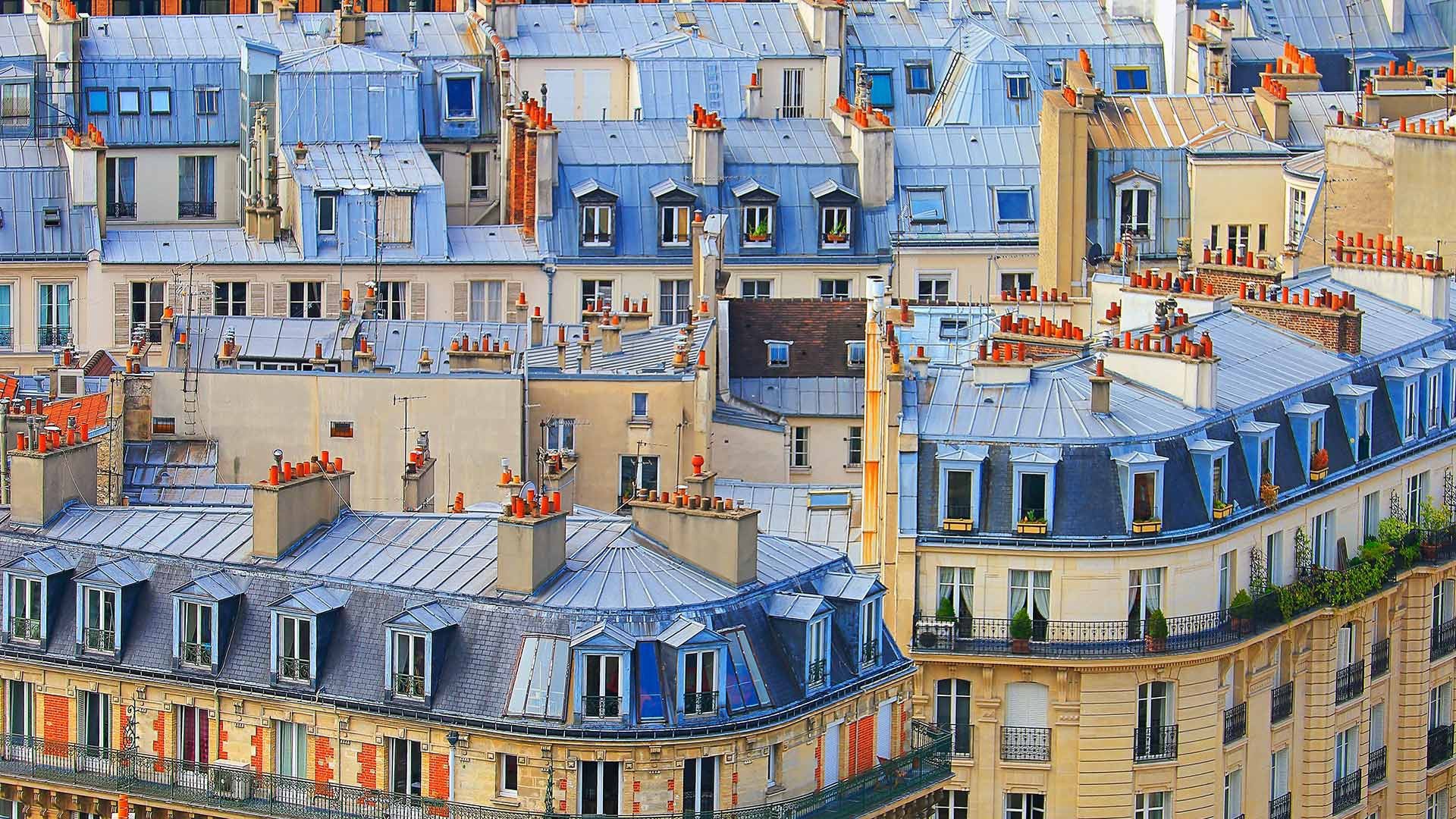 Parisian rooftops with dormer windows and chimneys HD Wallpaper