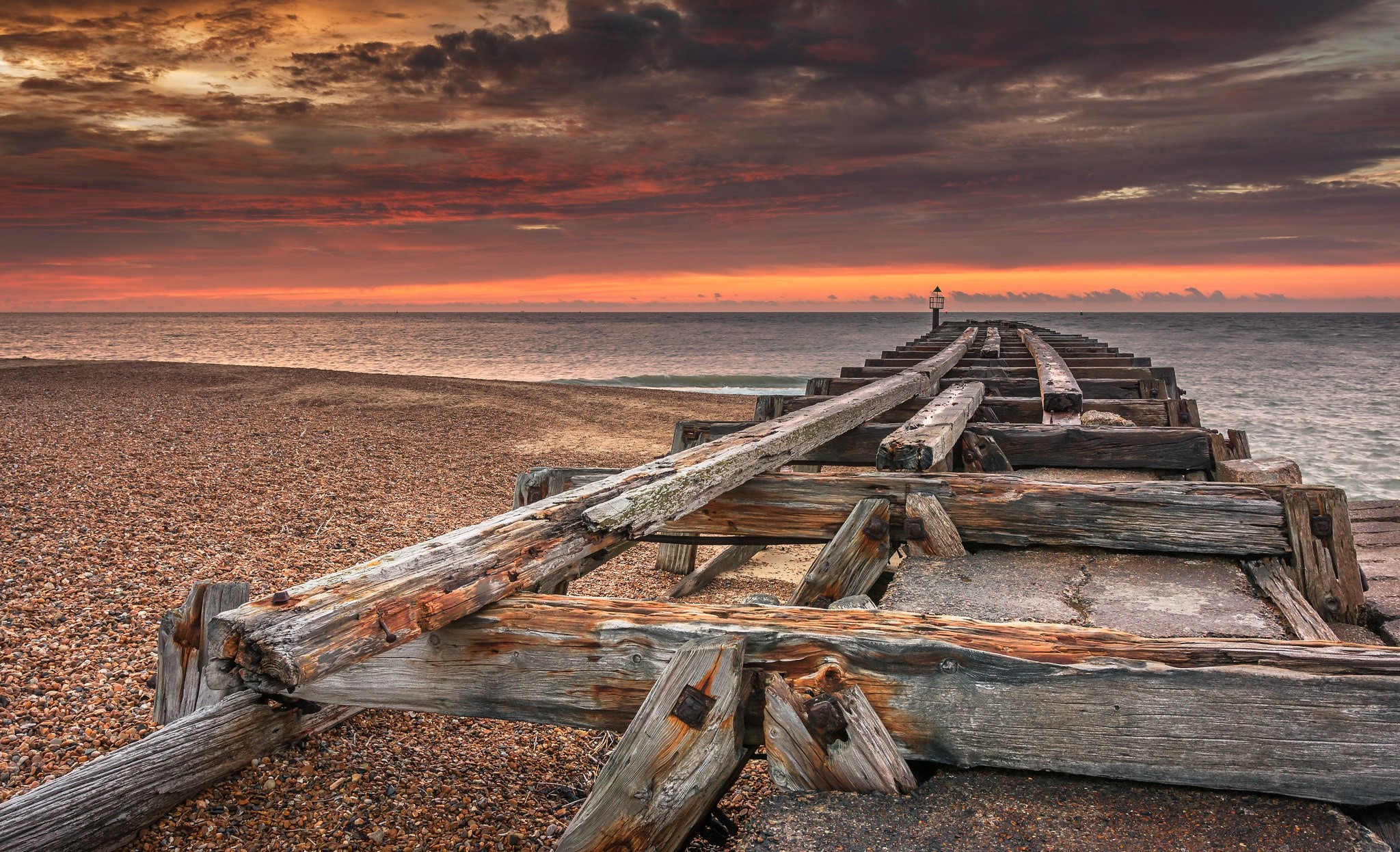 Wooden pier on a beach at sunset HD Wallpaper