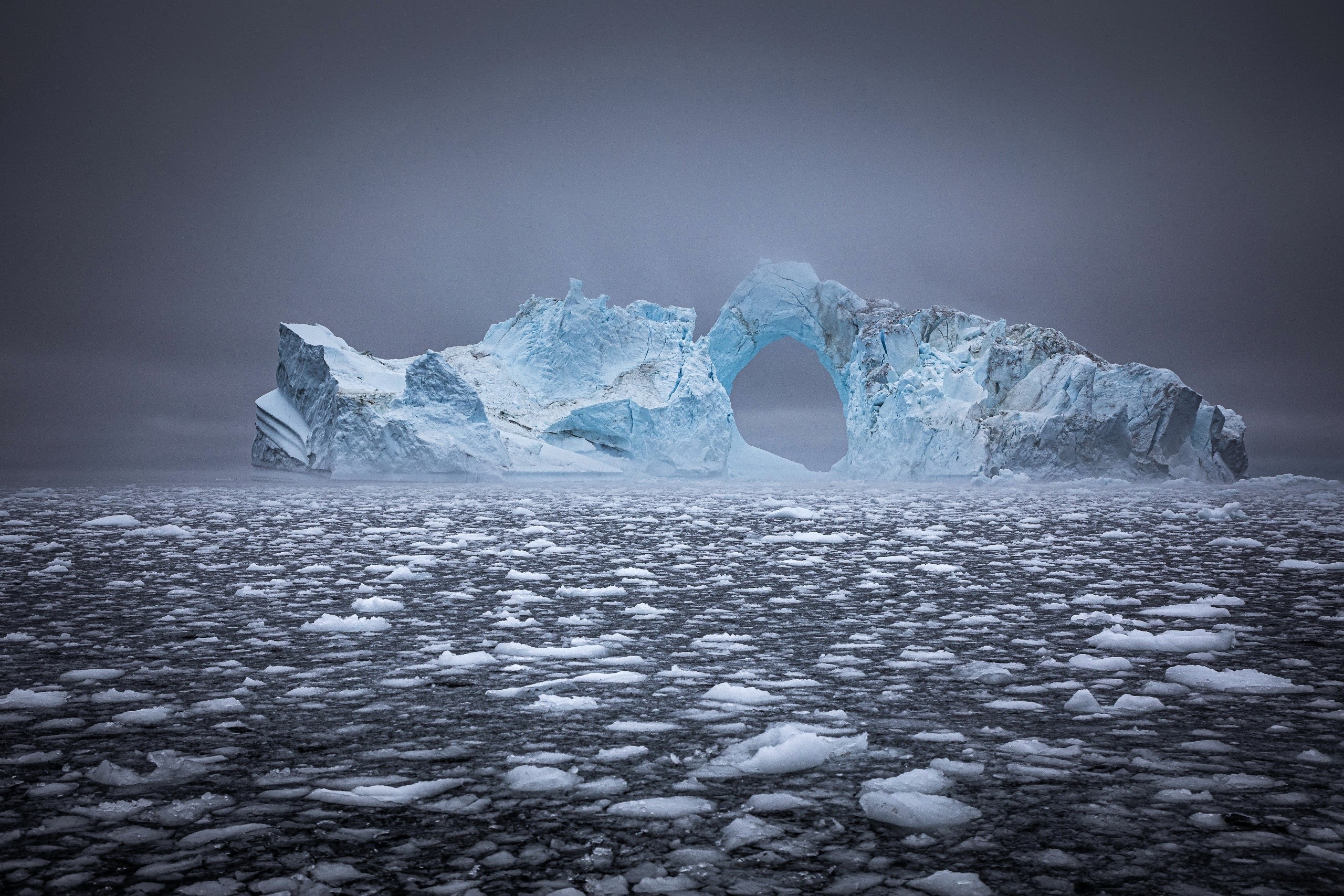 Iceberg with a hole in the middle in Greenland HD Wallpaper