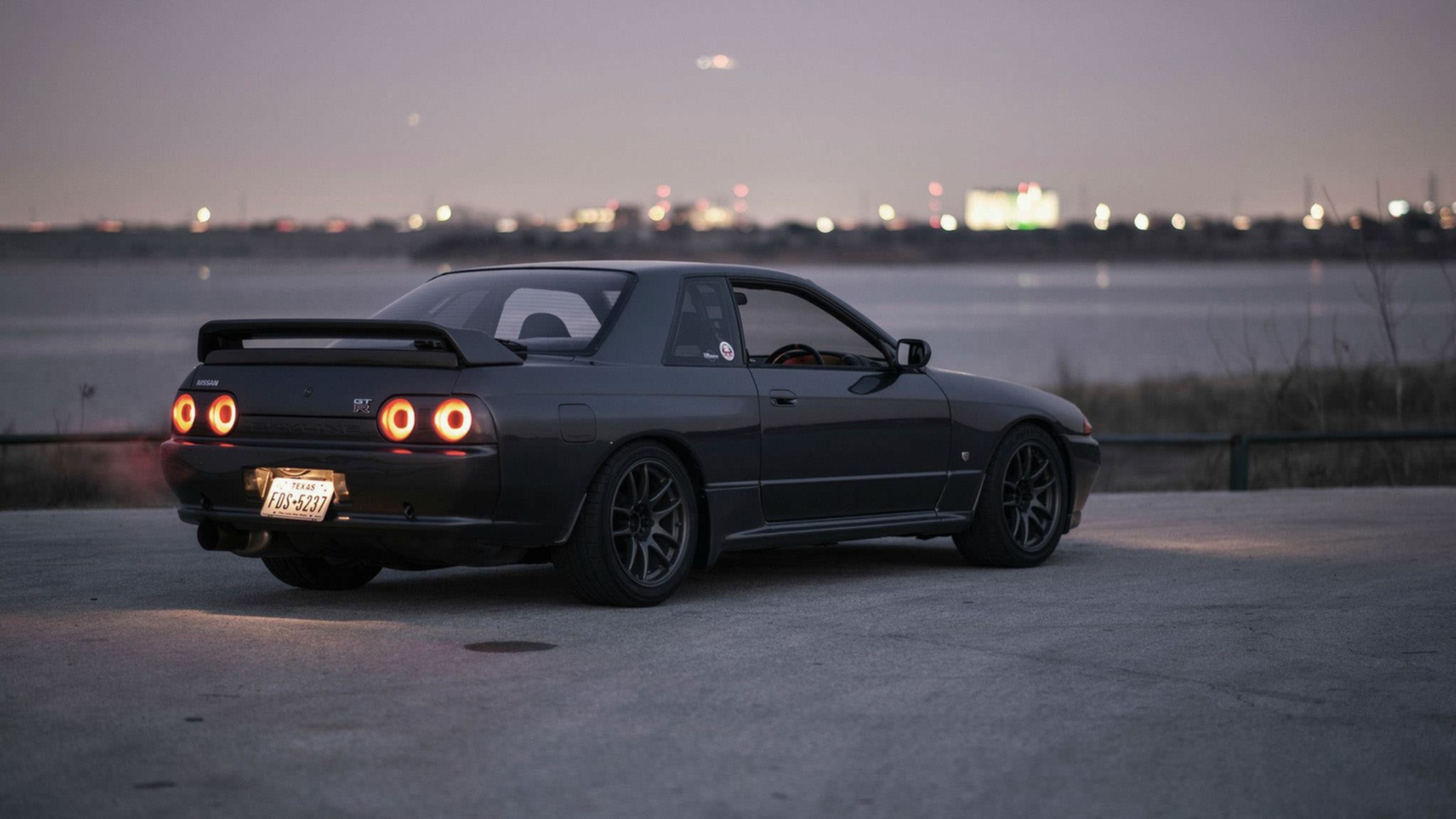 Nissan Skyline GT-R R-32 parked by a lake at dusk HD Wallpaper