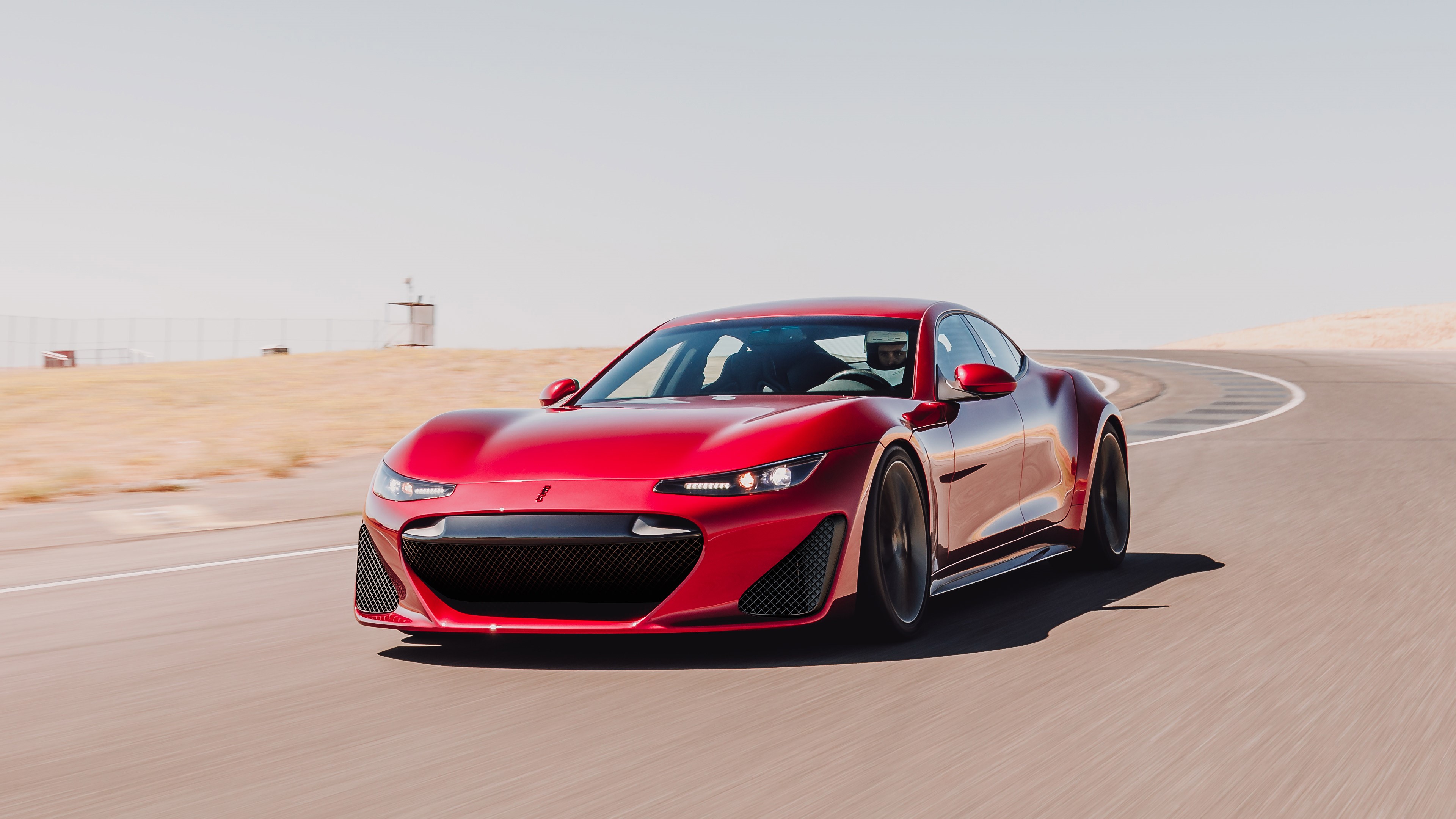 Red Drako GTE electric car on a race track HD Wallpaper