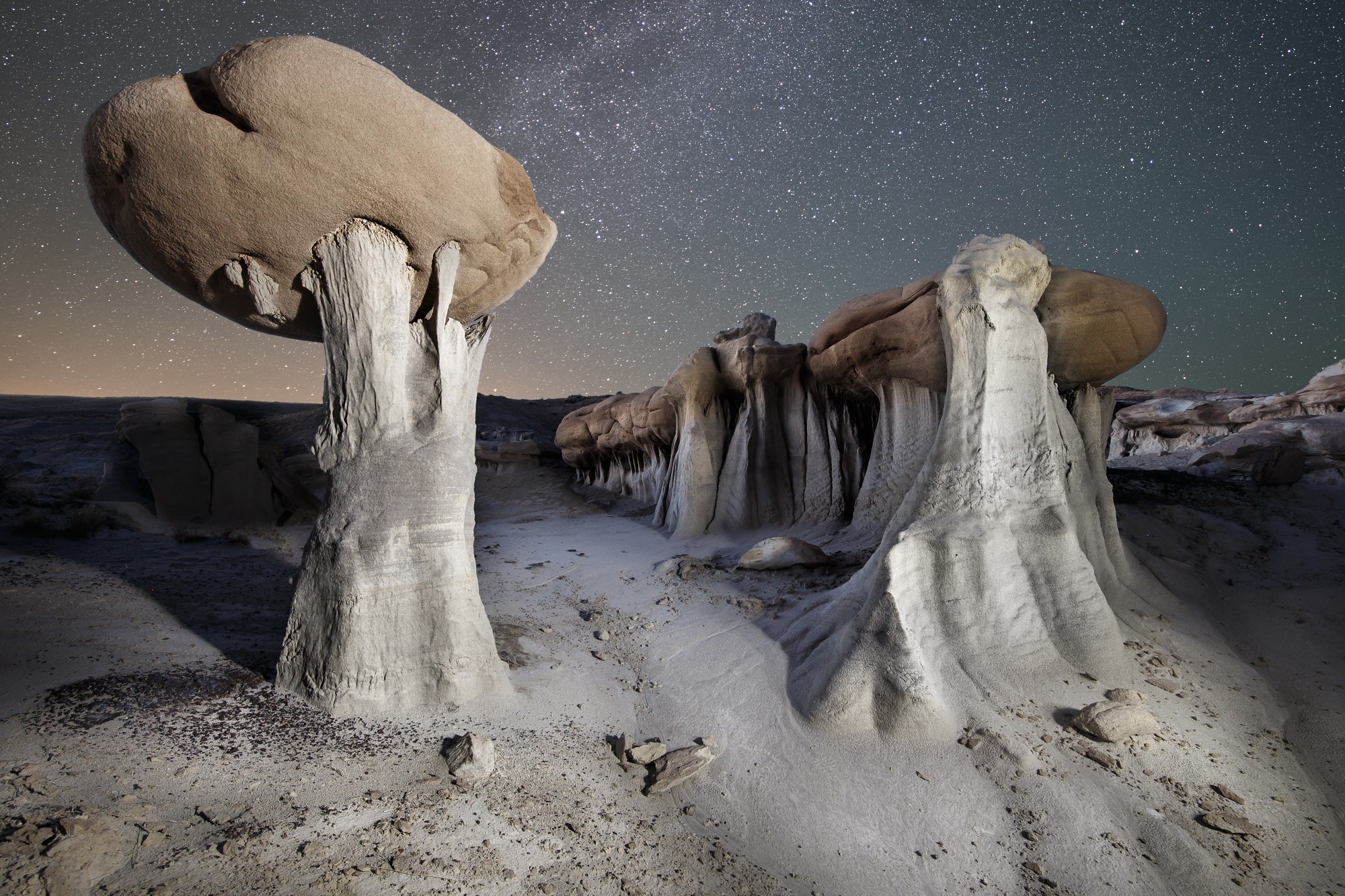 Rock formations under a starry sky HD Wallpaper