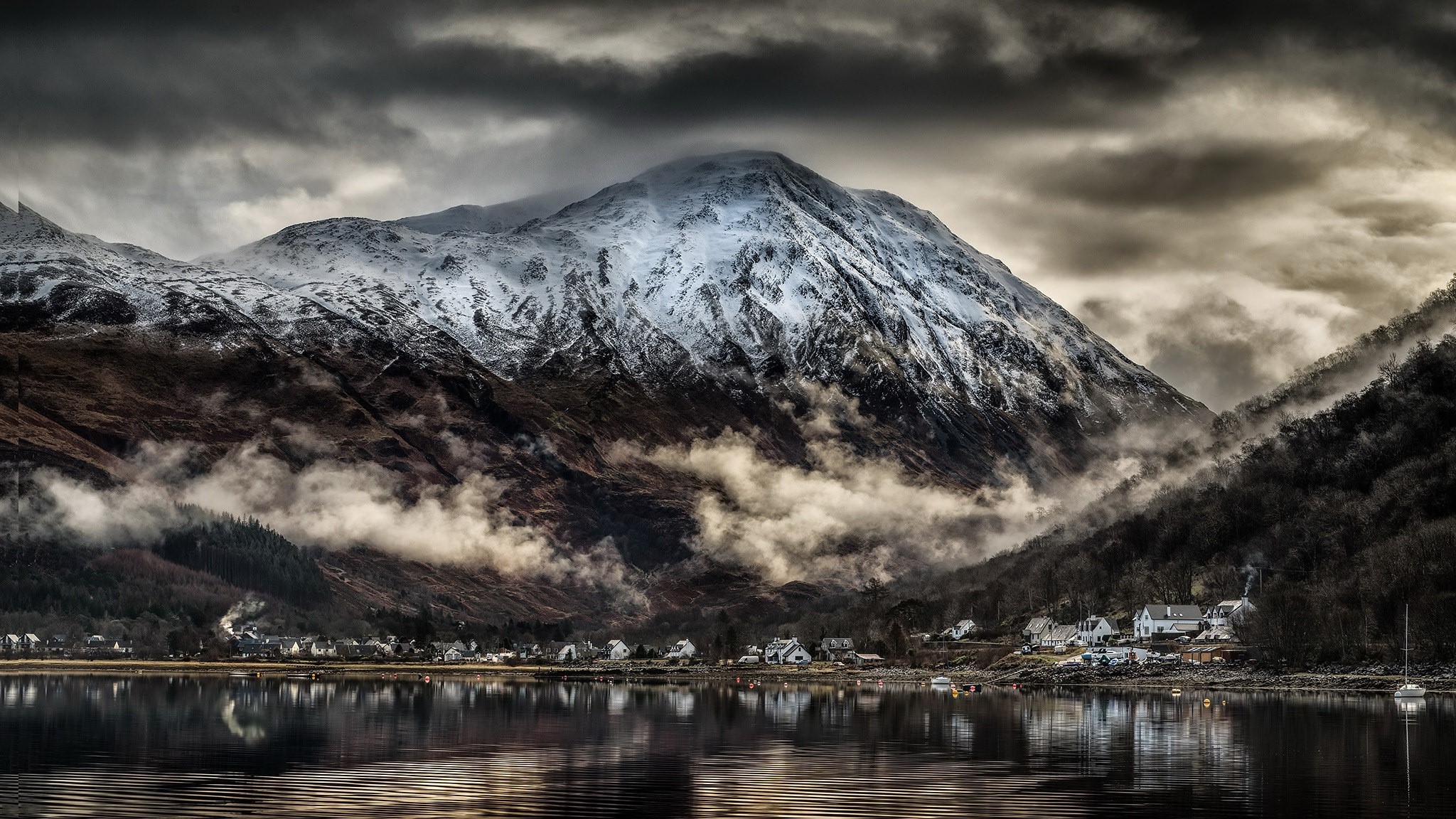 Snow-capped mountains over a village by a lake in Scotland HD Wallpaper