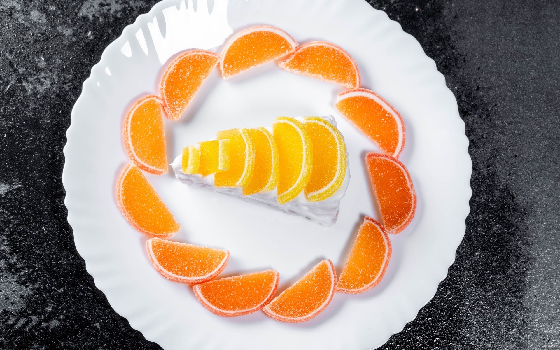 Slice of cake with orange and yellow jelly slices on a white plate HD Wallpaper