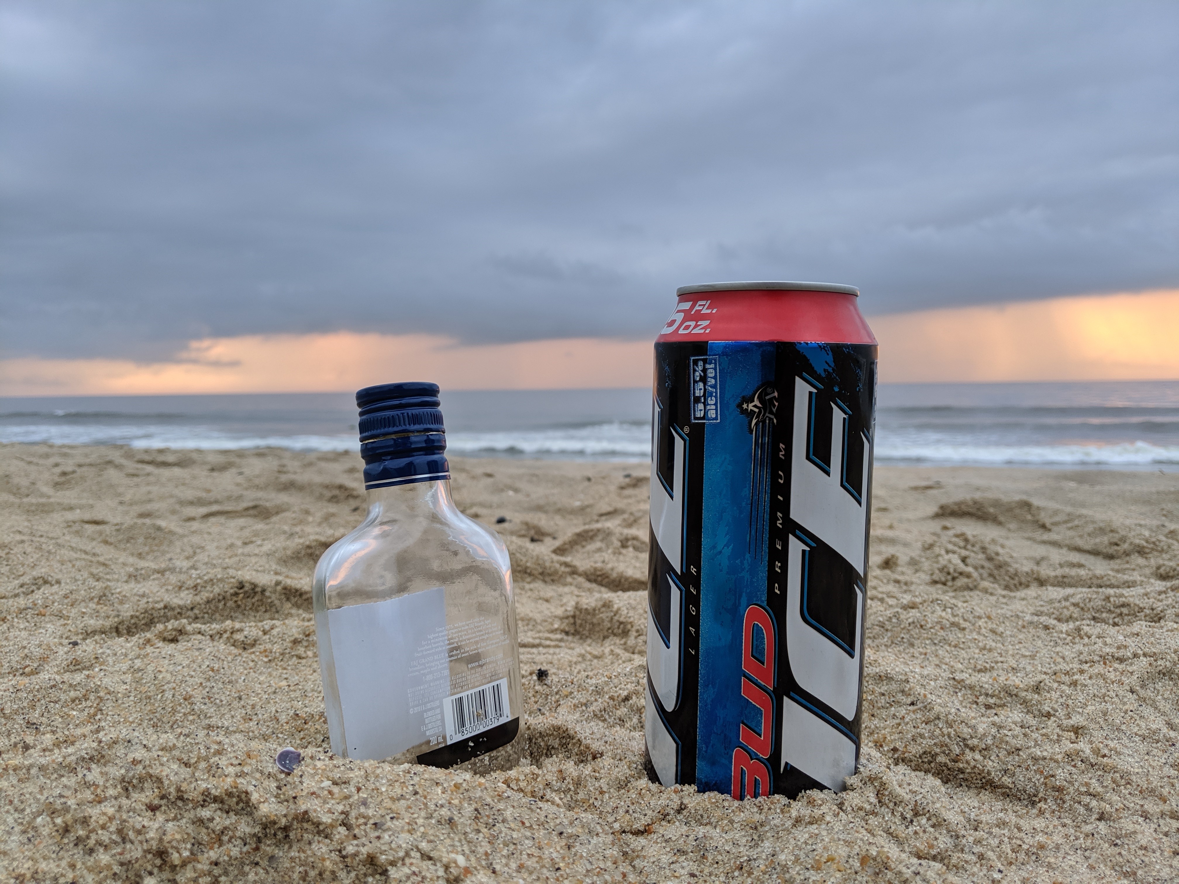 Budweiser beer can and bottle on beach HD Wallpaper