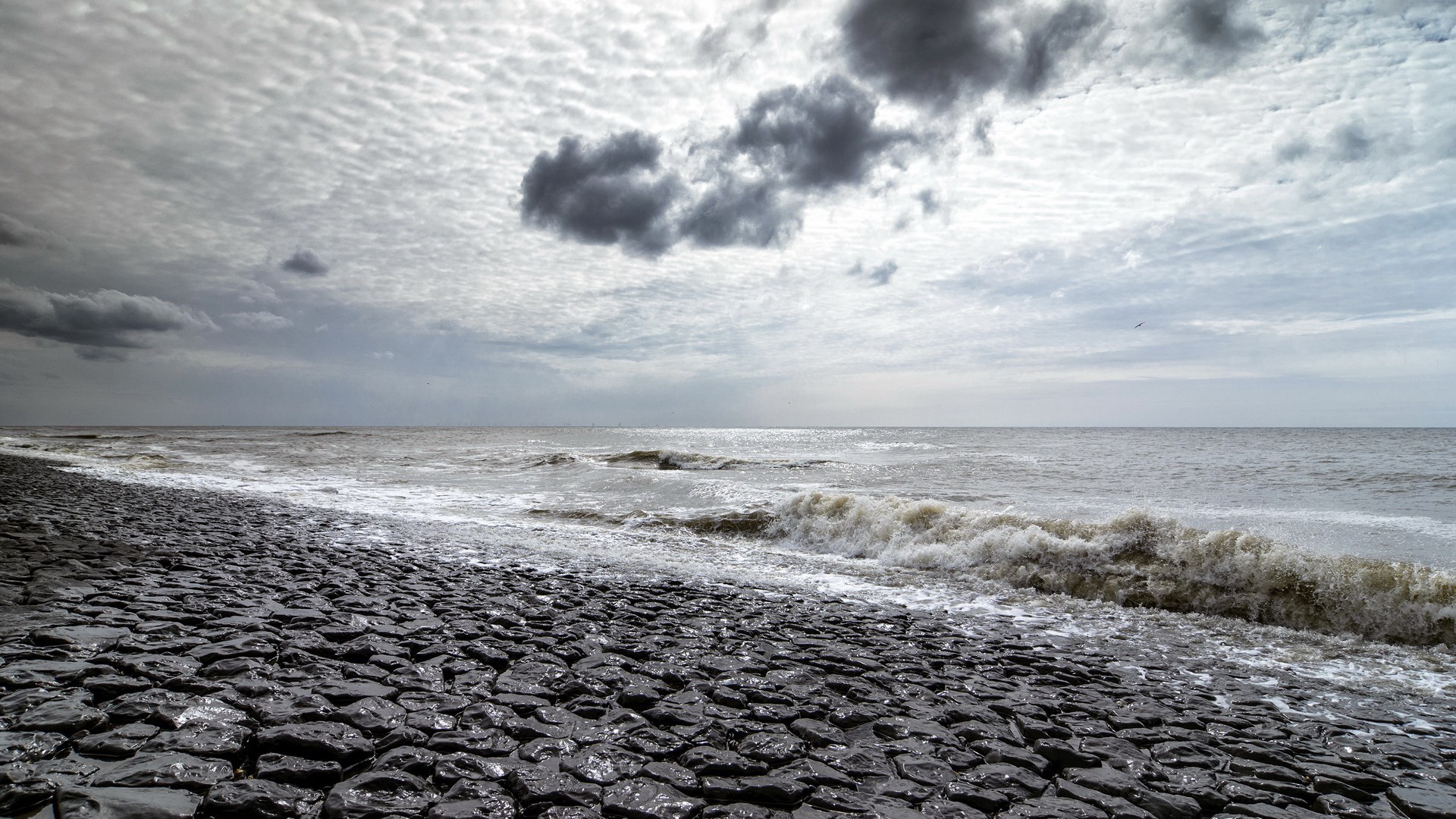 Rocky Shoreline with Waves Under Cloudy Sky HD Wallpaper