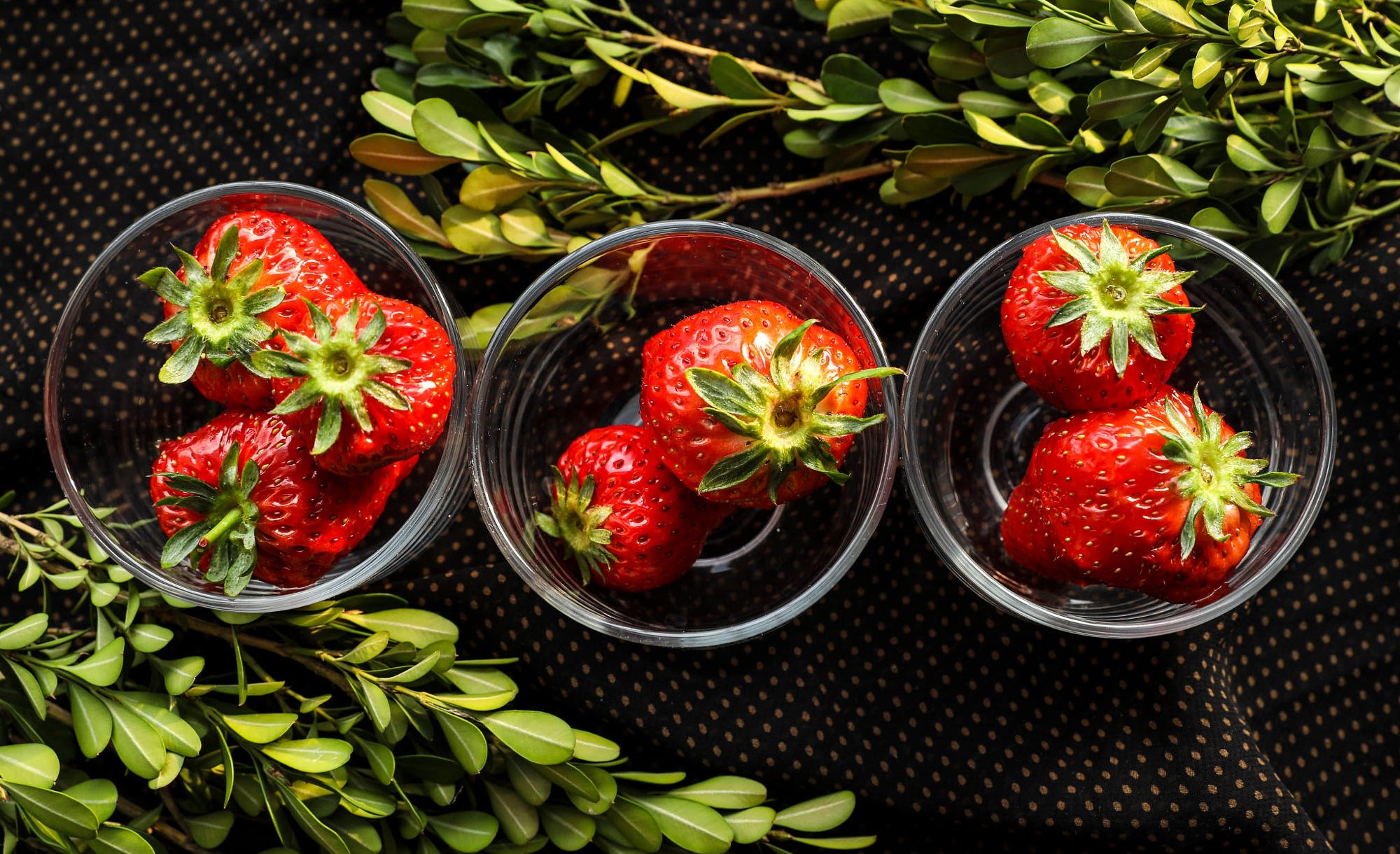 Strawberries in glass bowls with greenery HD Wallpaper