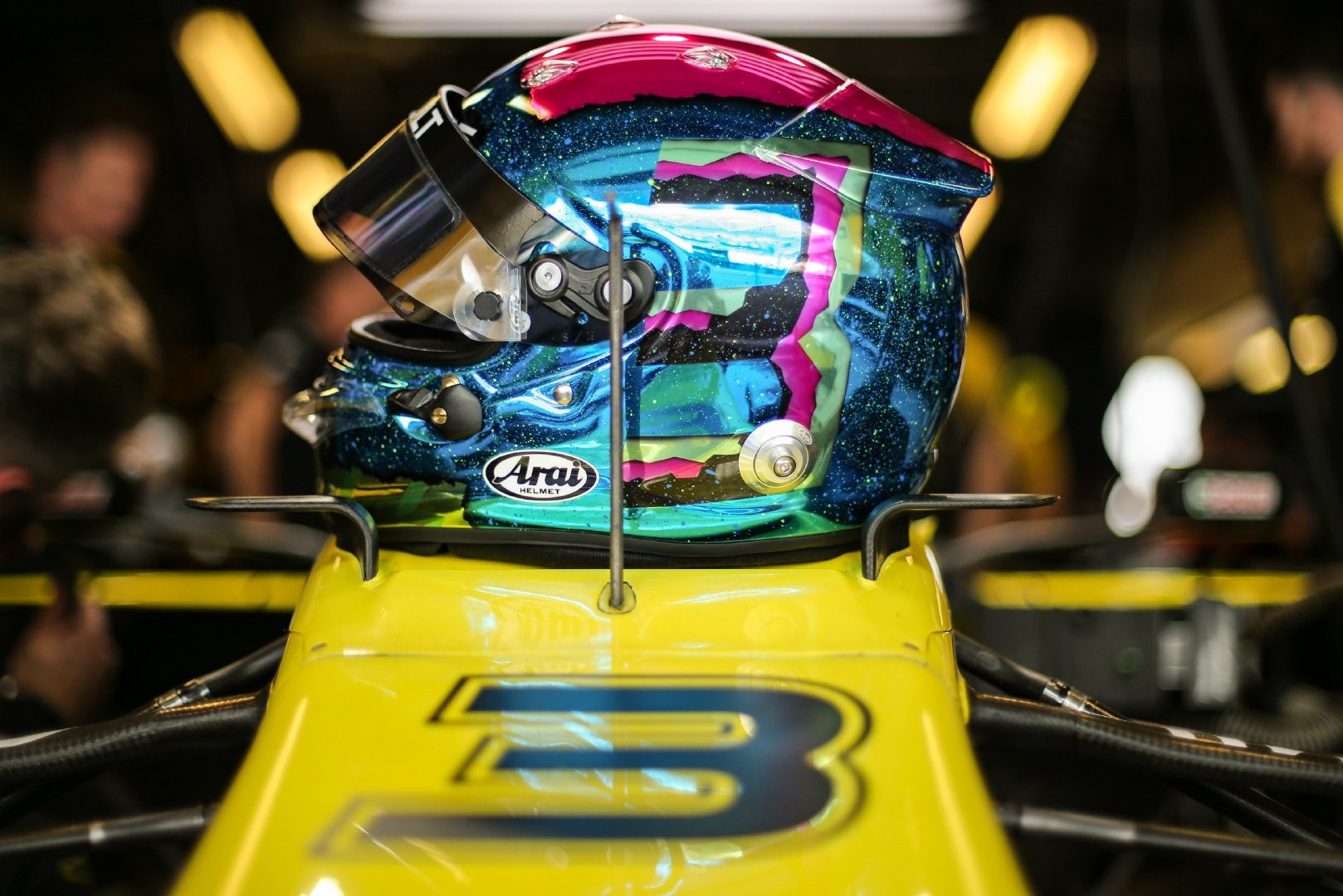 Daniel Ricciardo's Arai Helmet on a Yellow Formula 1 Car HD Wallpaper