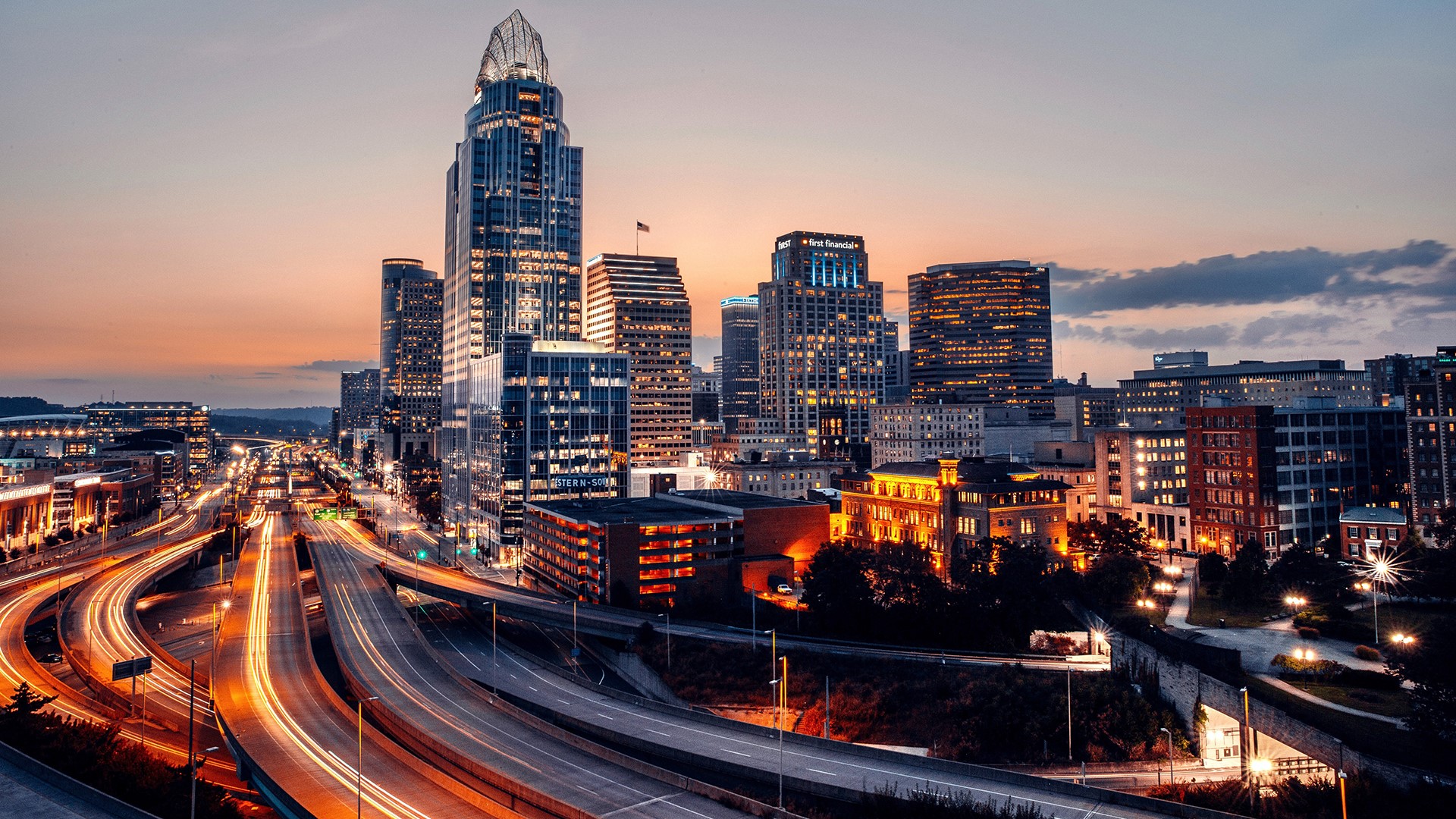 Cincinnati skyline at sunset with light trails on highway HD Wallpaper