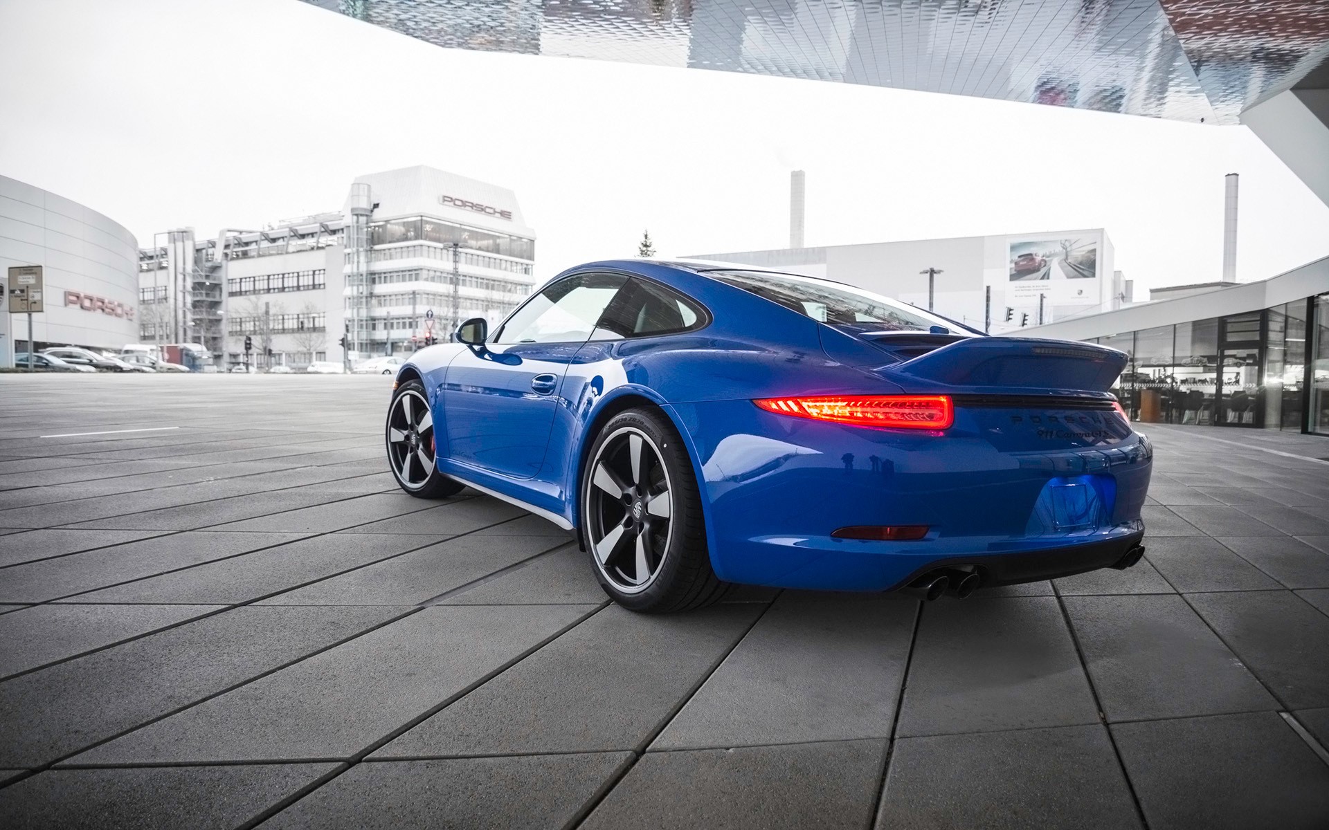 Blue Porsche 911 parked outside Porsche Museum HD Wallpaper