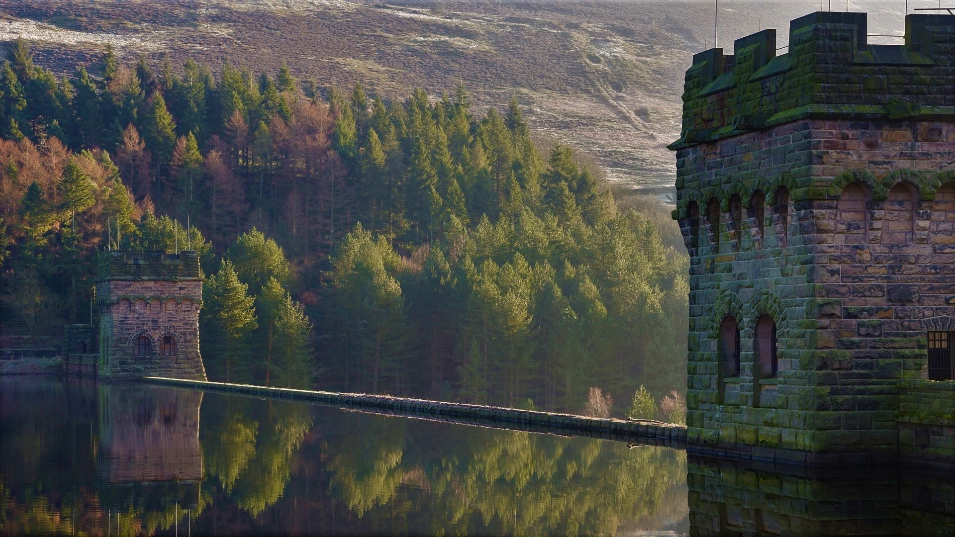 Stone towers and trees reflected in a reservoir in the UK HD Wallpaper