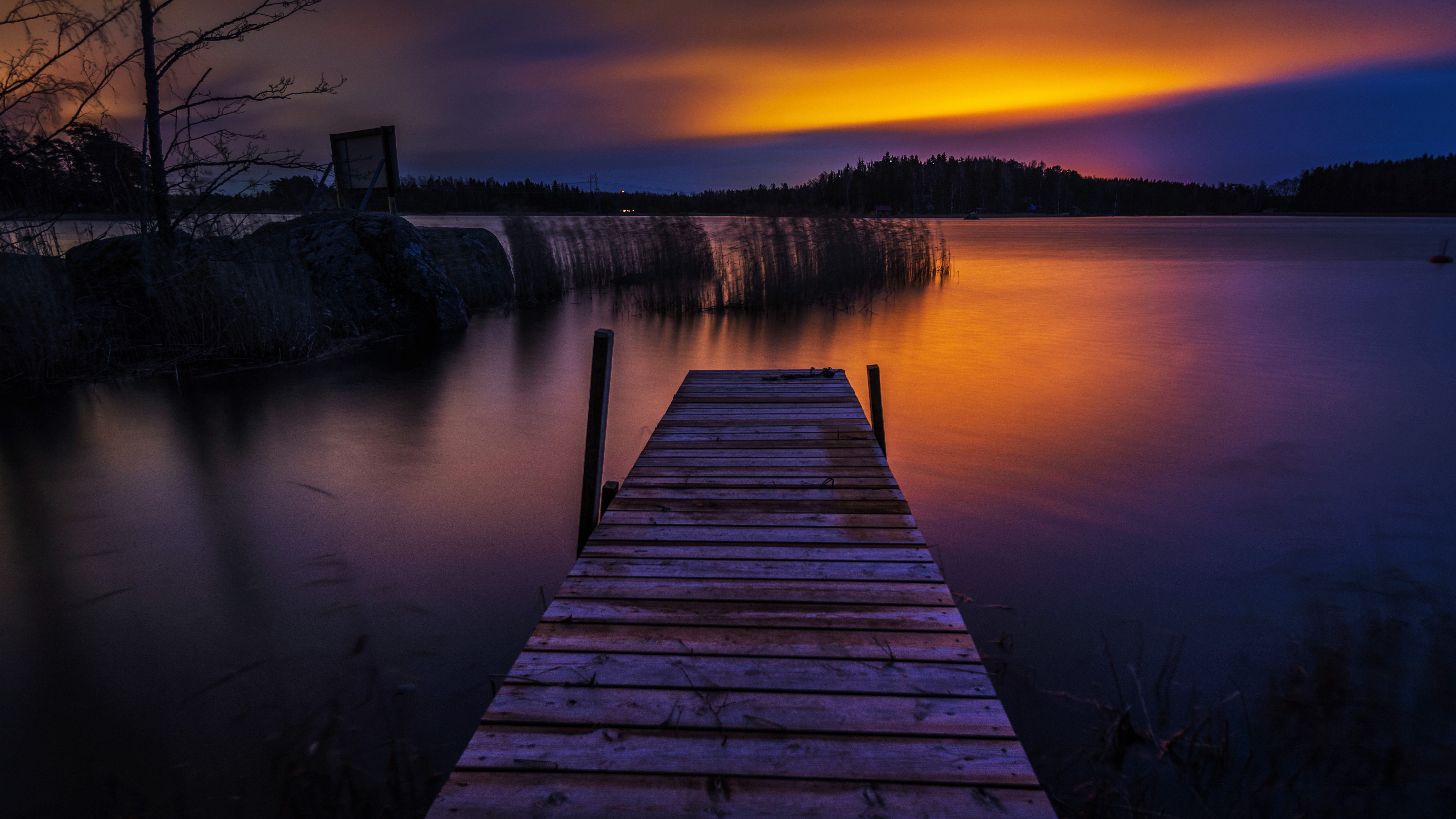 Sunset over lake with wooden dock in Finland HD Wallpaper