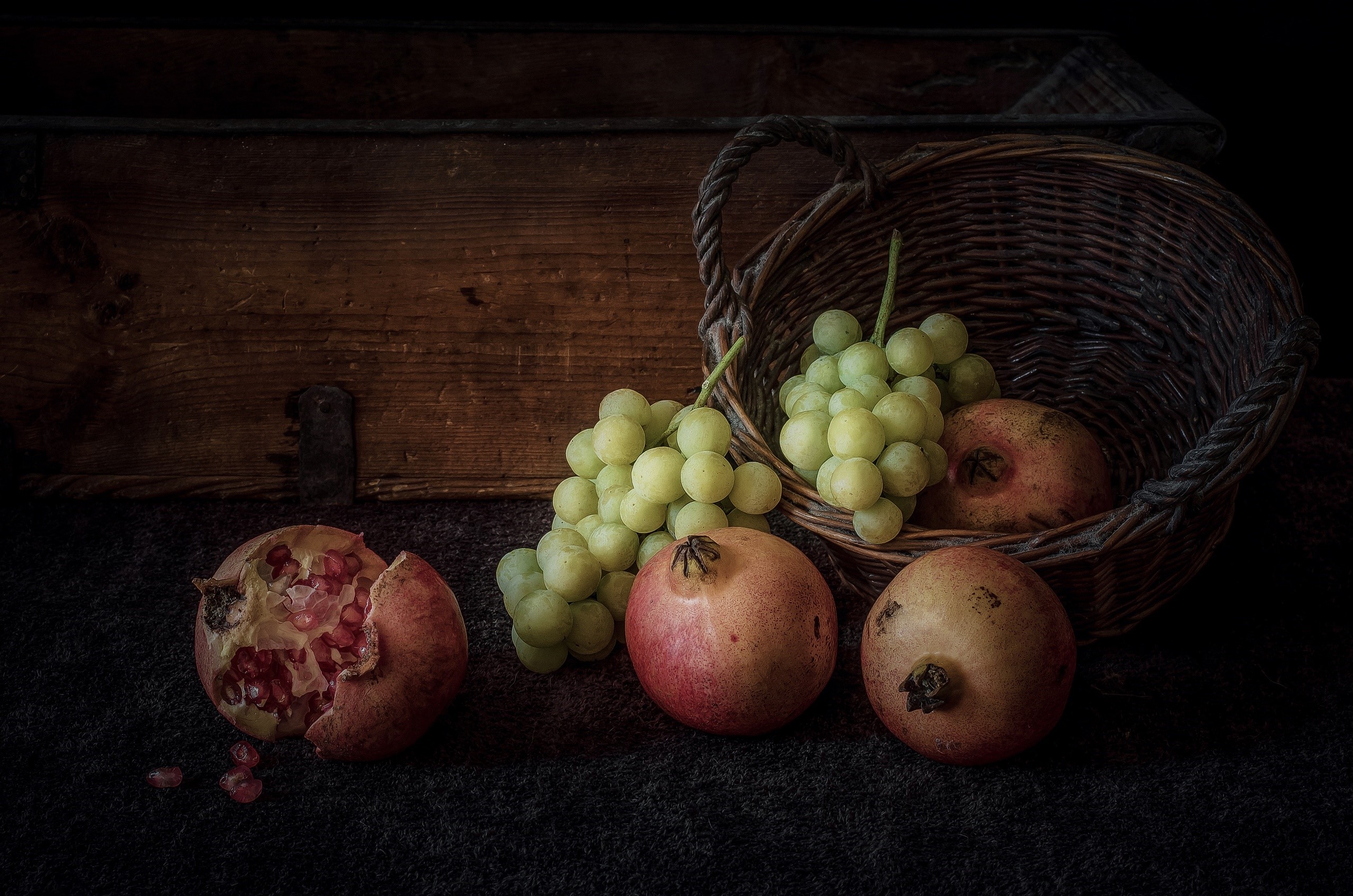 Still life of pomegranates and grapes in a basket HD Wallpaper
