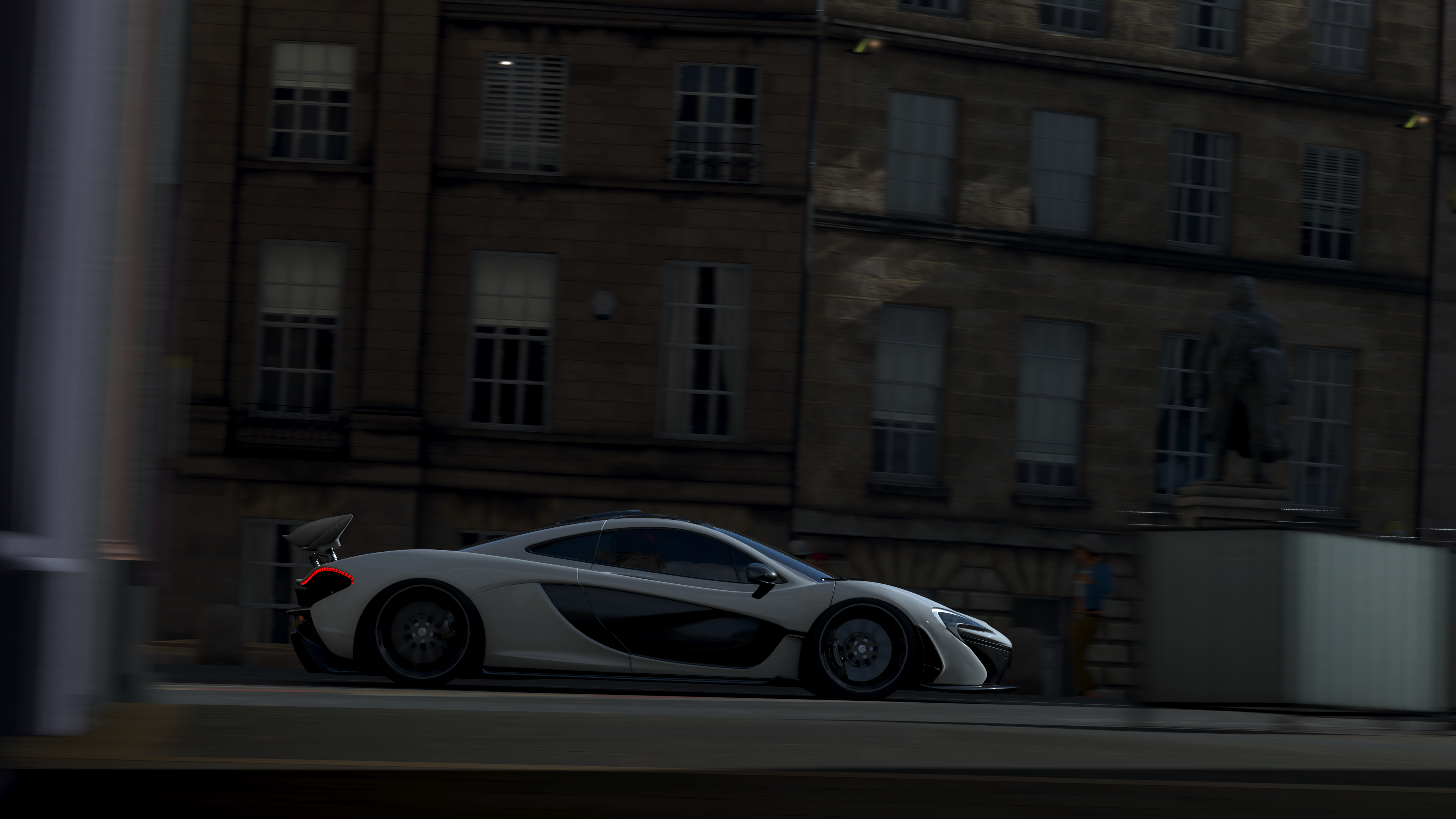 White McLaren P1 driving past buildings in Forza Horizon 4 HD Wallpaper