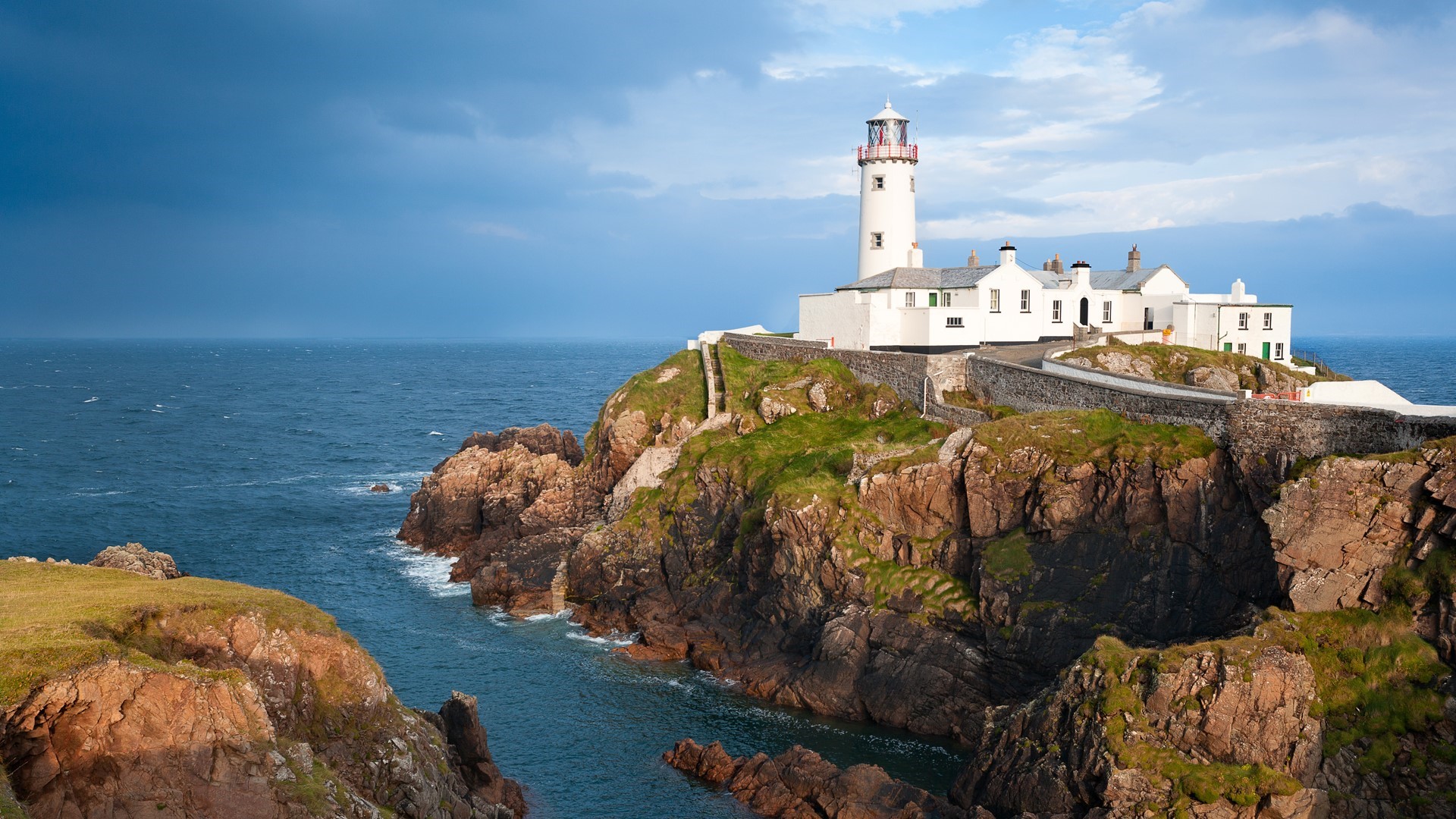 Fanad Head Lighthouse on a rocky coast in Ireland HD Wallpaper
