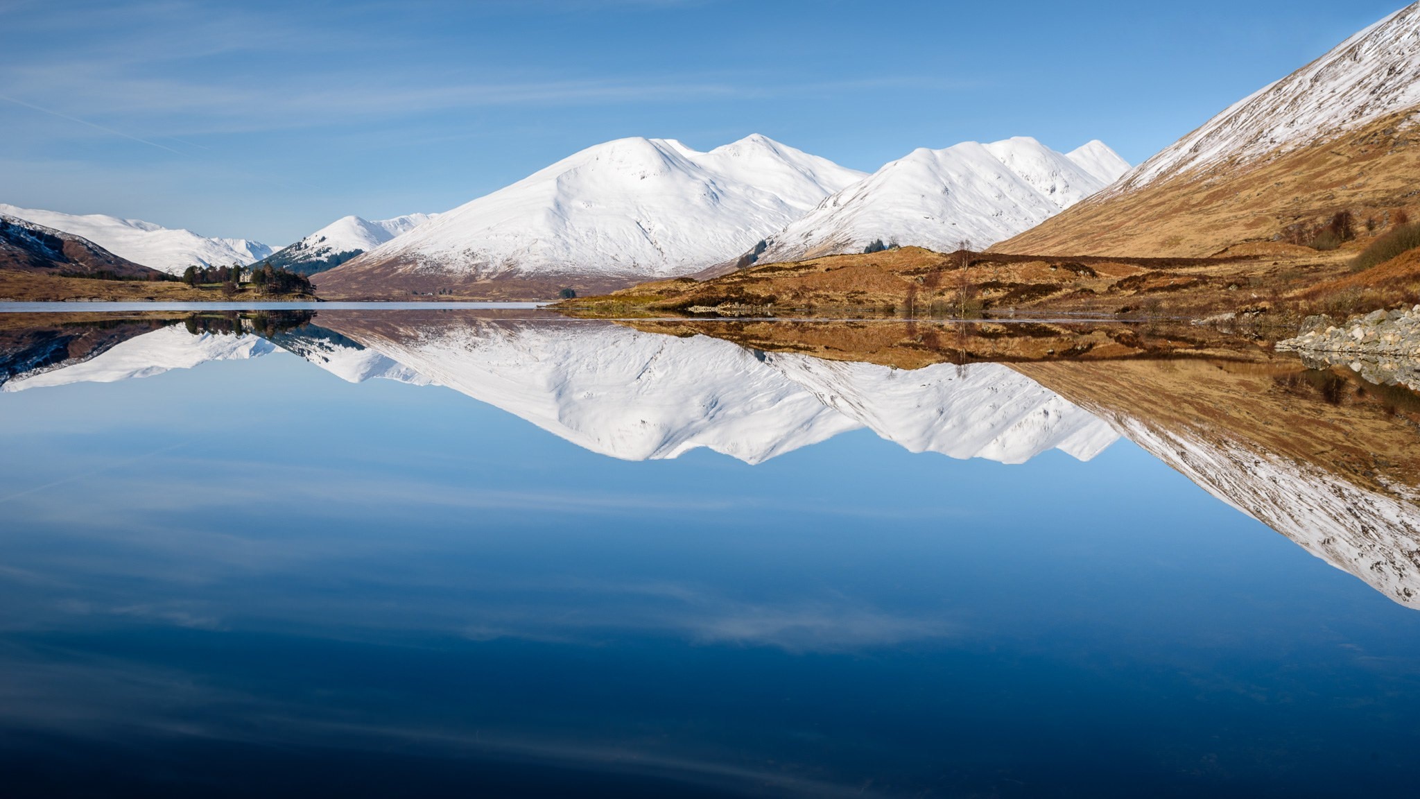 Snow-capped mountains reflected in a calm lake HD Wallpaper