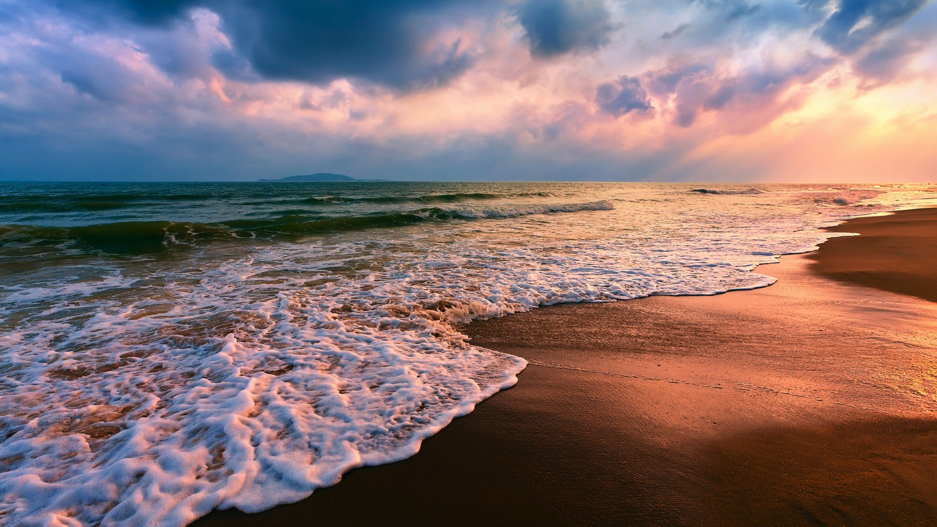 Ocean waves crashing on a sandy beach at sunset HD Wallpaper