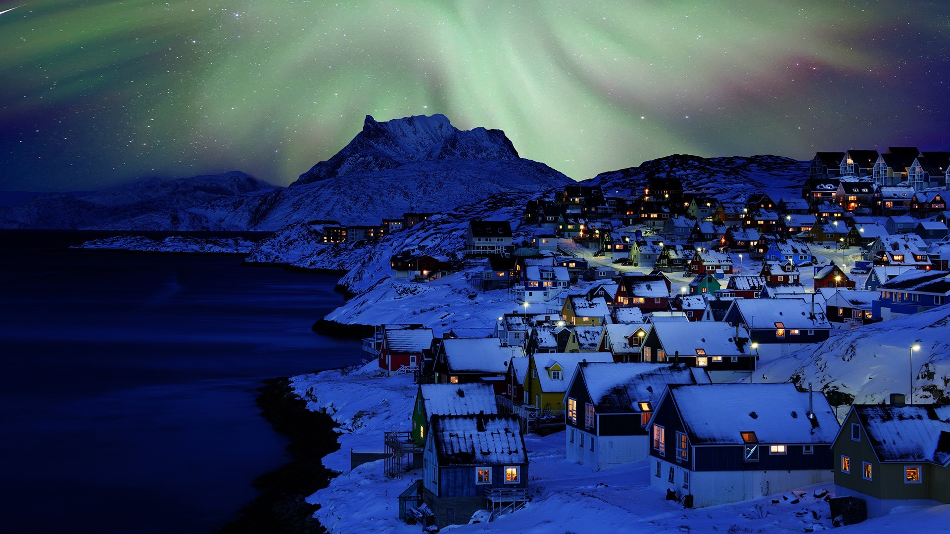 Town on a snowy coast under the aurora borealis HD Wallpaper