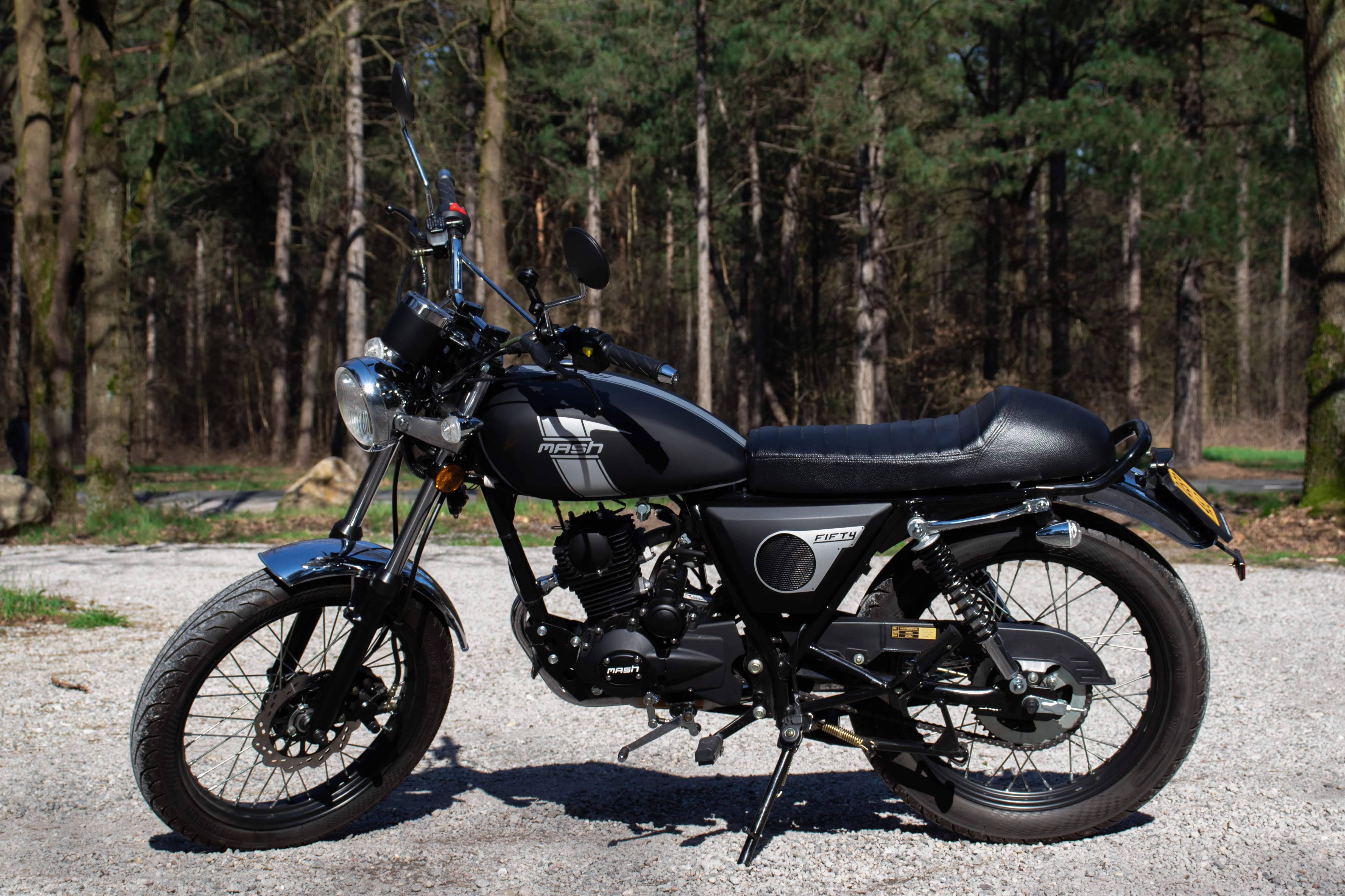 Mash Fifty moped in a forest setting HD Wallpaper