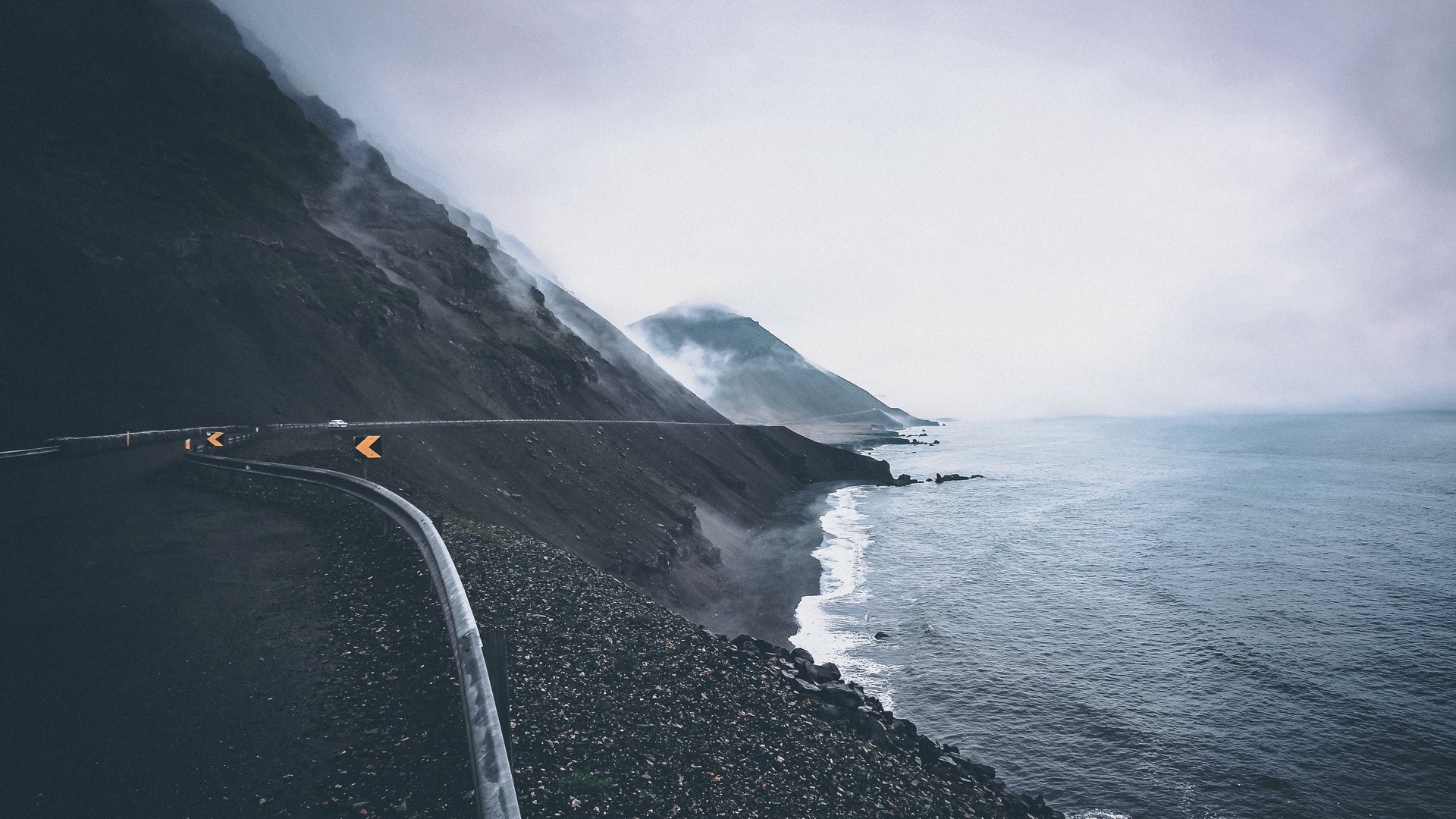 Coastal road with mountains and sea in mist HD Wallpaper