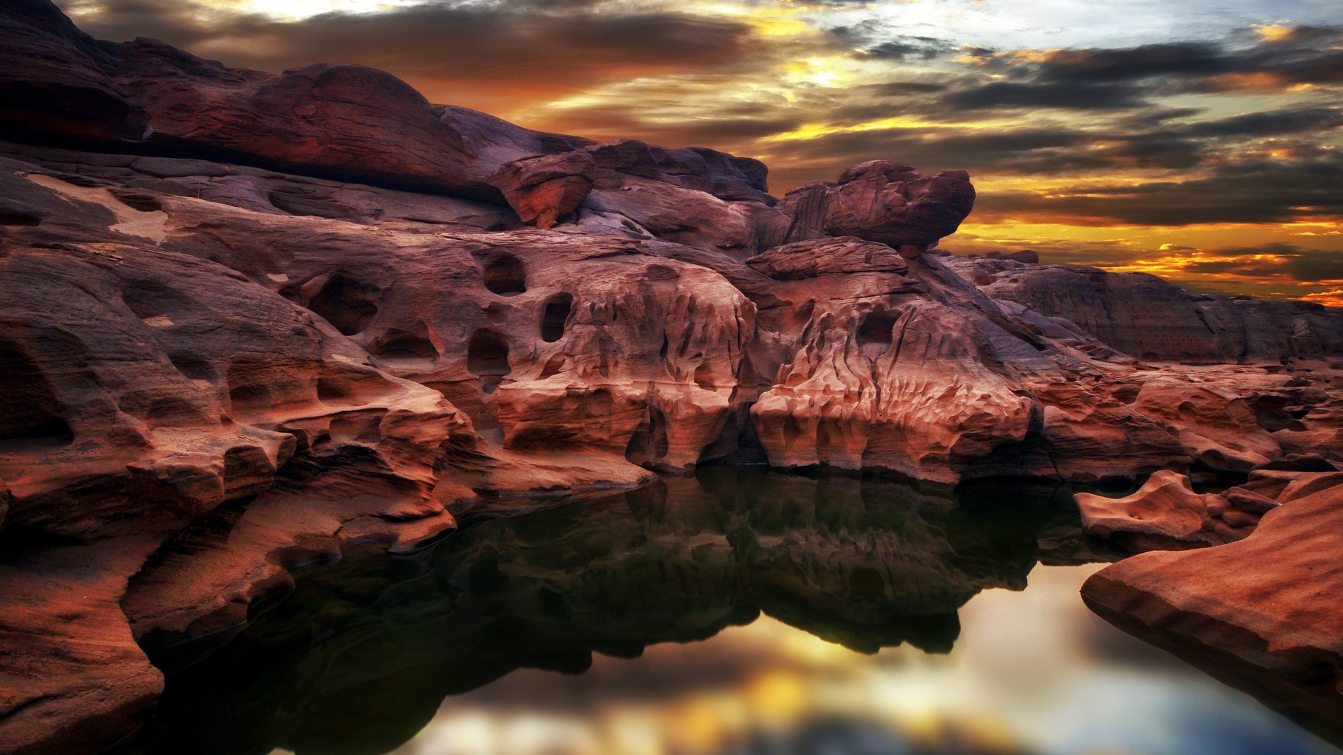 Rocky canyon with water reflection at sunset HD Wallpaper