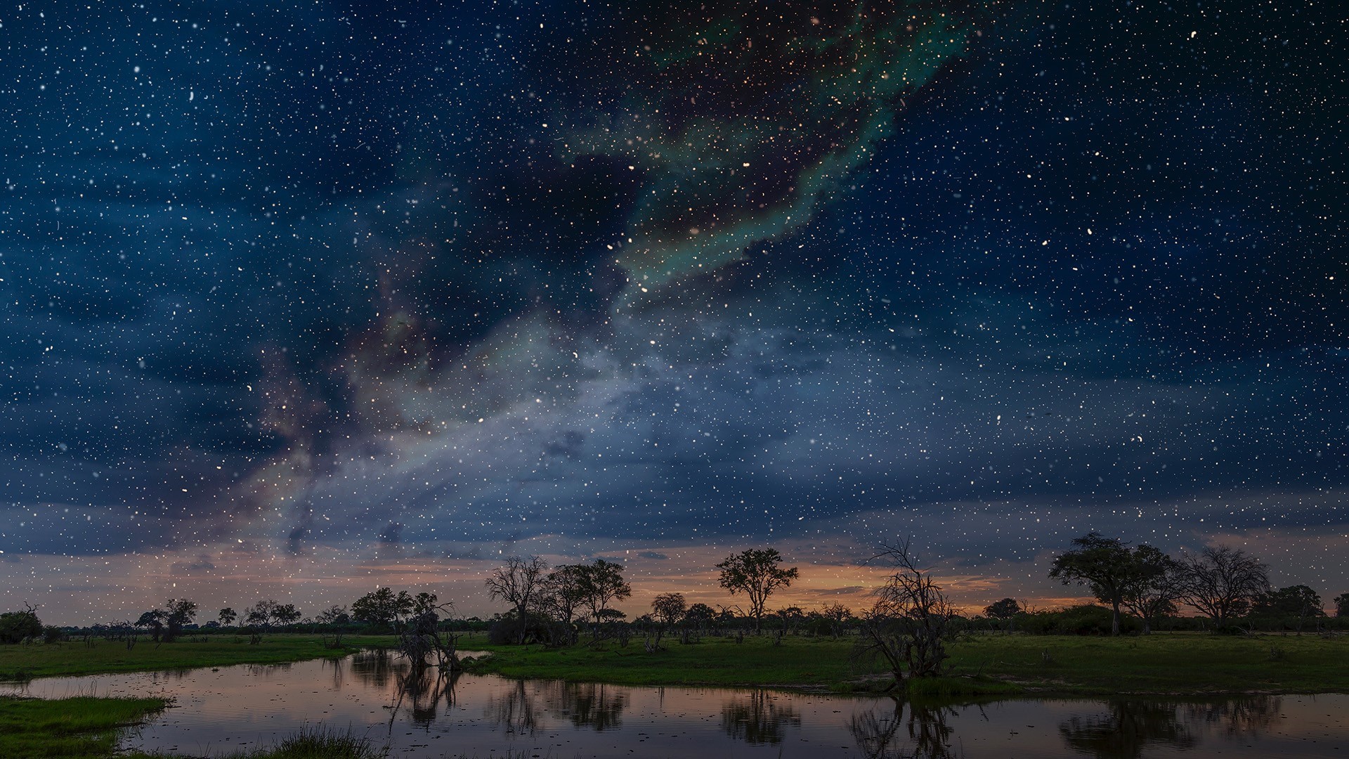 Night sky over a savanna landscape with a pond HD Wallpaper