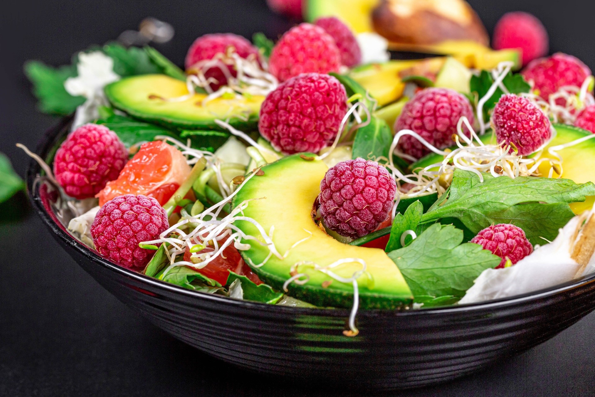 Salad with raspberries, avocado, and sprouts in a bowl HD Wallpaper