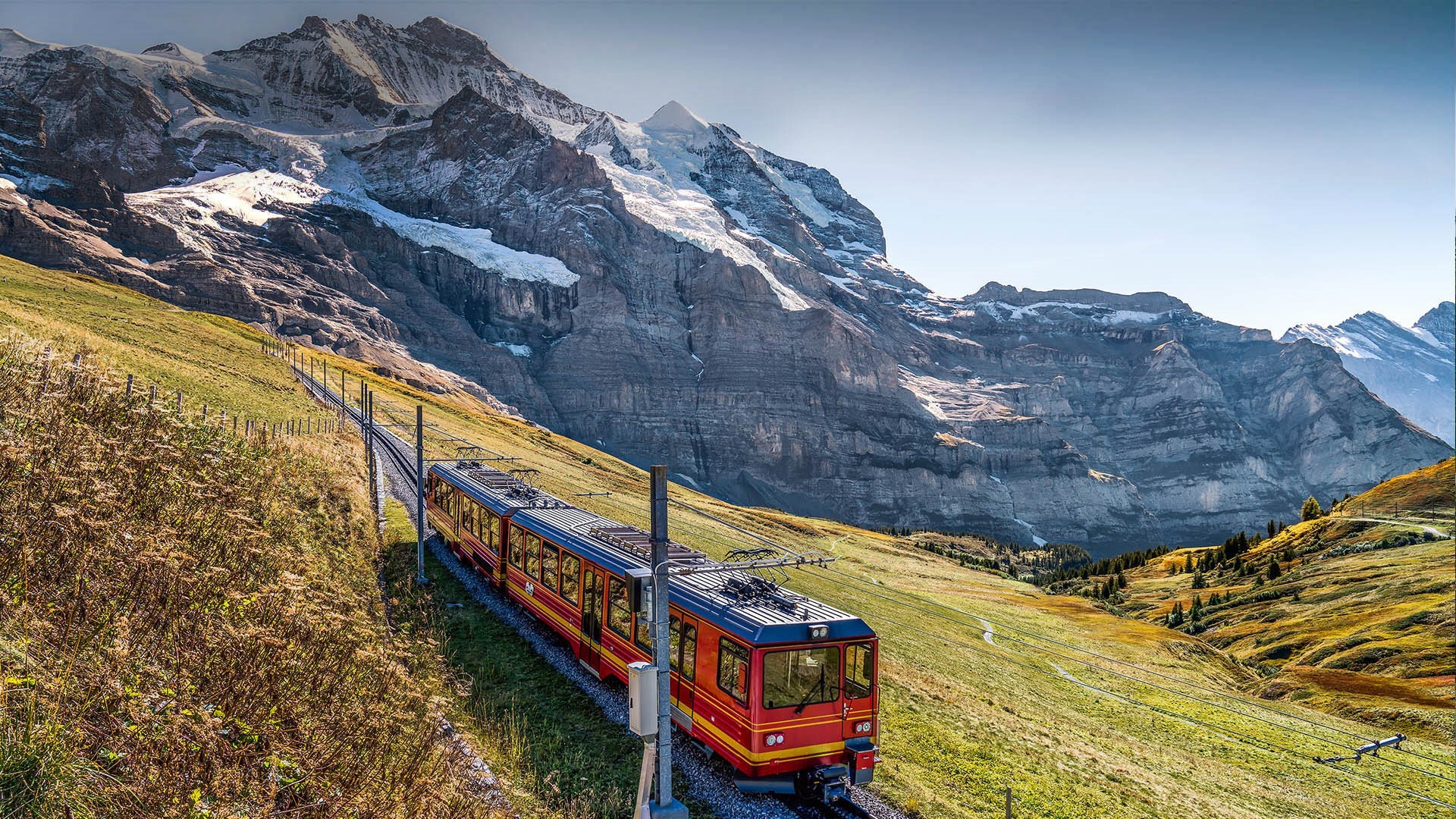 Red train on a mountain railway in Switzerland HD Wallpaper