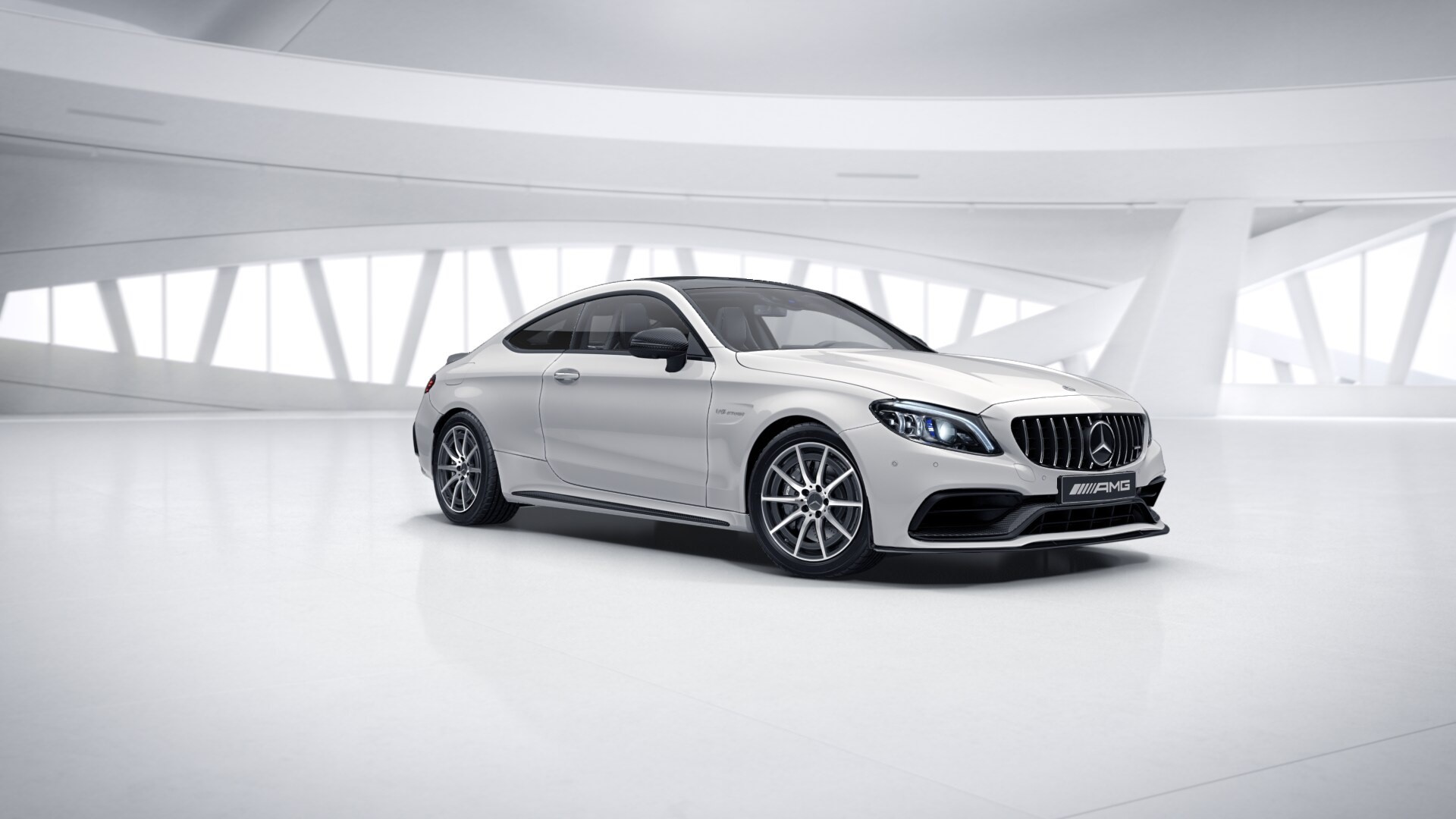 White Mercedes-Benz C63 AMG Coupe in a modern showroom HD Wallpaper