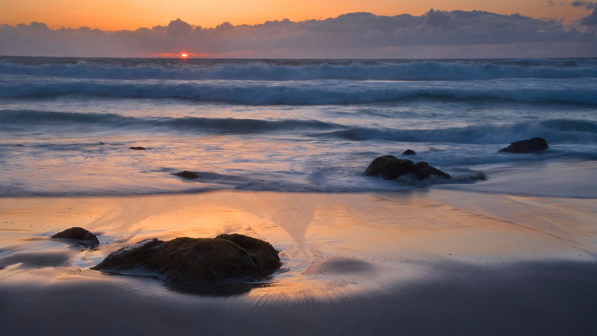 Sunset over the ocean with waves and rocks HD Wallpaper