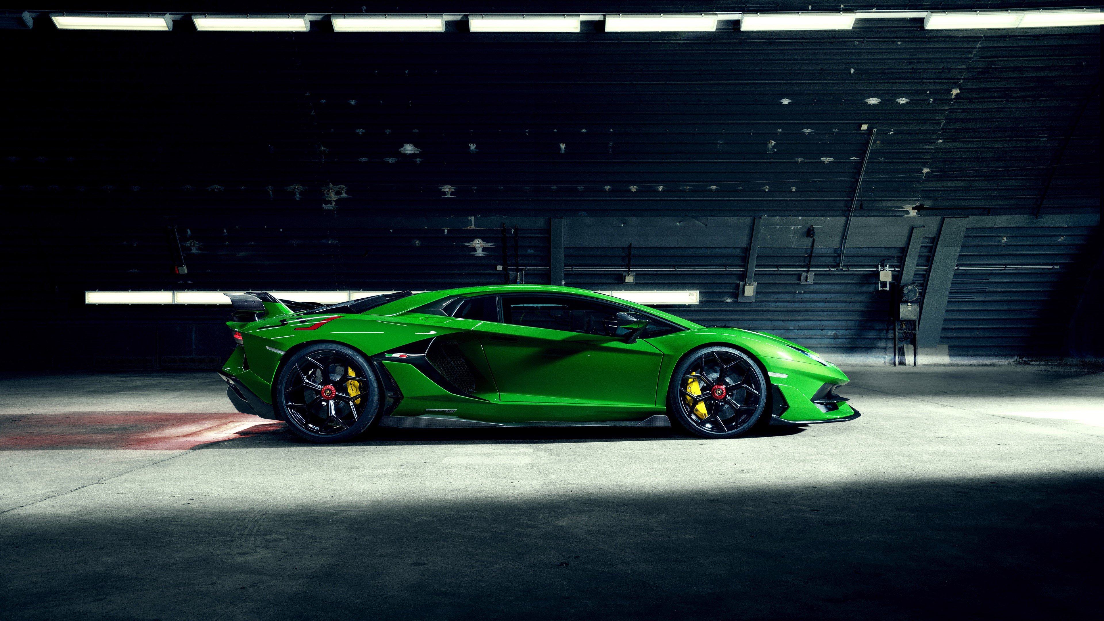 Green Lamborghini Aventador SVJ in a hangar HD Wallpaper