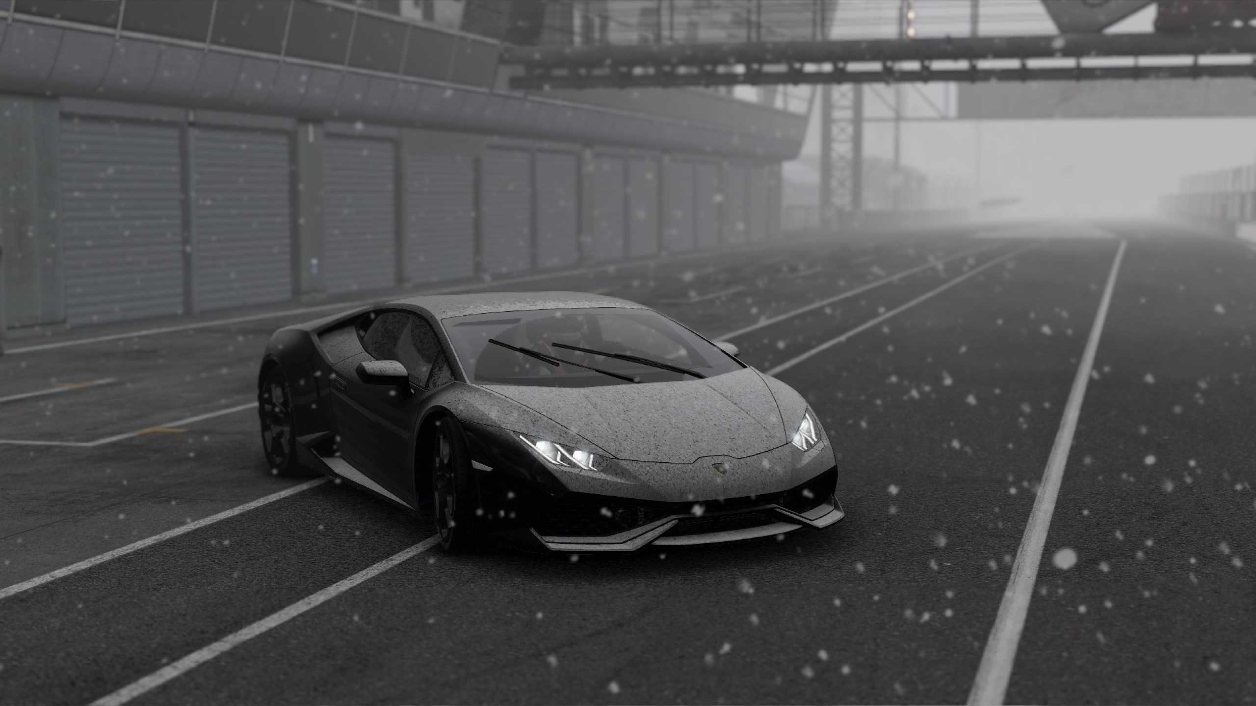 Black Lamborghini Huracan on a wet race track in snow HD Wallpaper