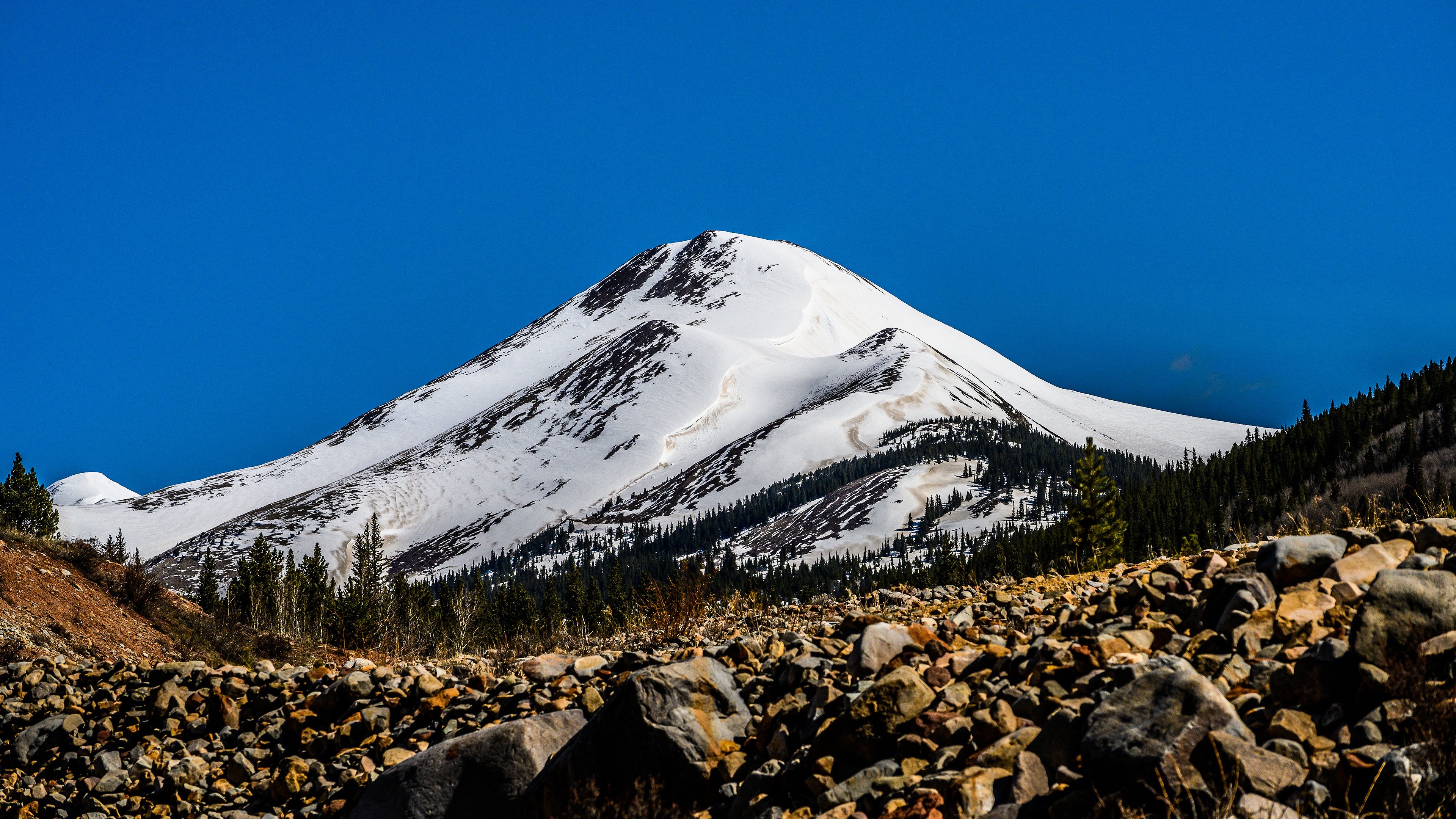 Snow-covered mountains under a clear blue sky HD Wallpaper