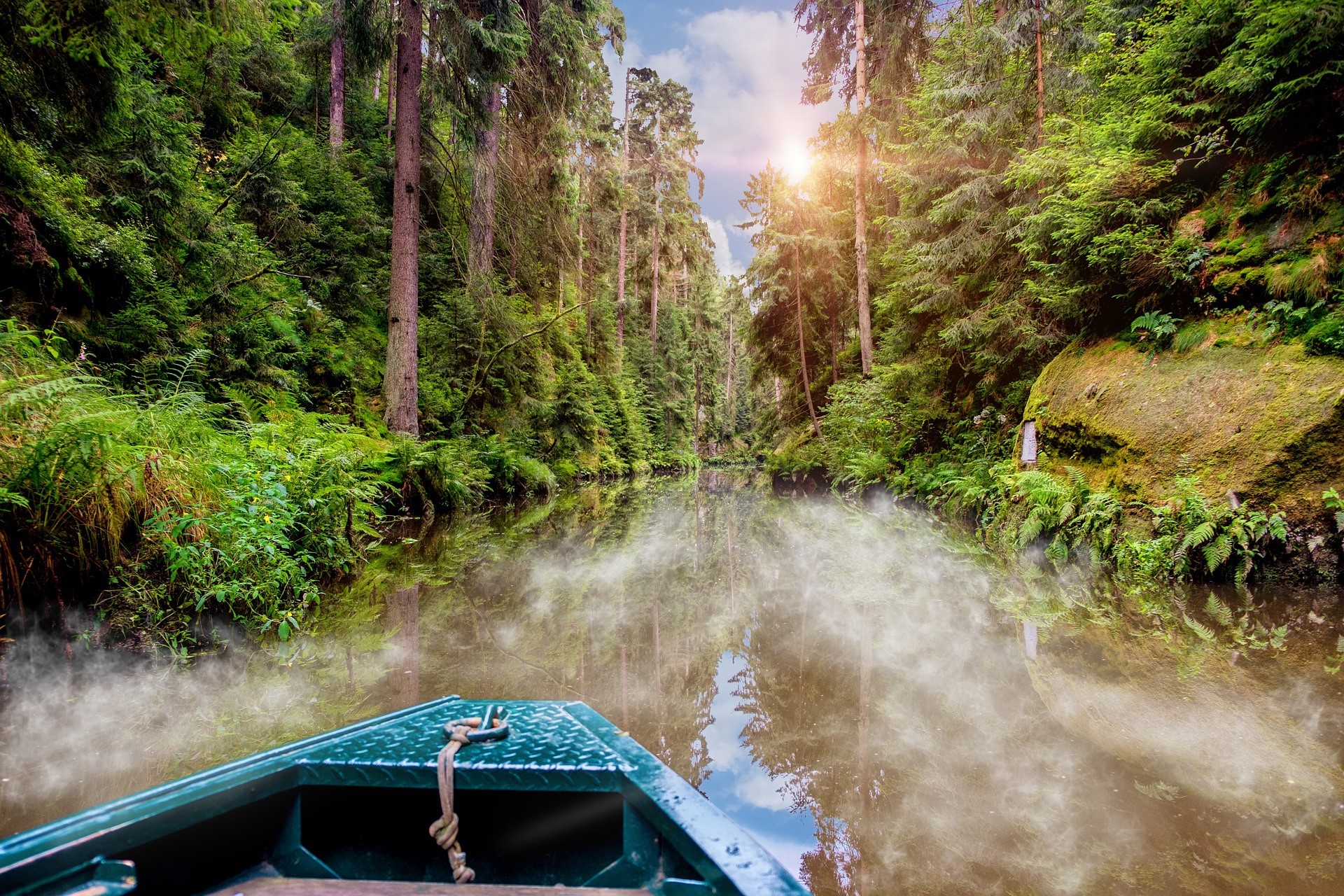 Boat on a misty river through a forest HD Wallpaper