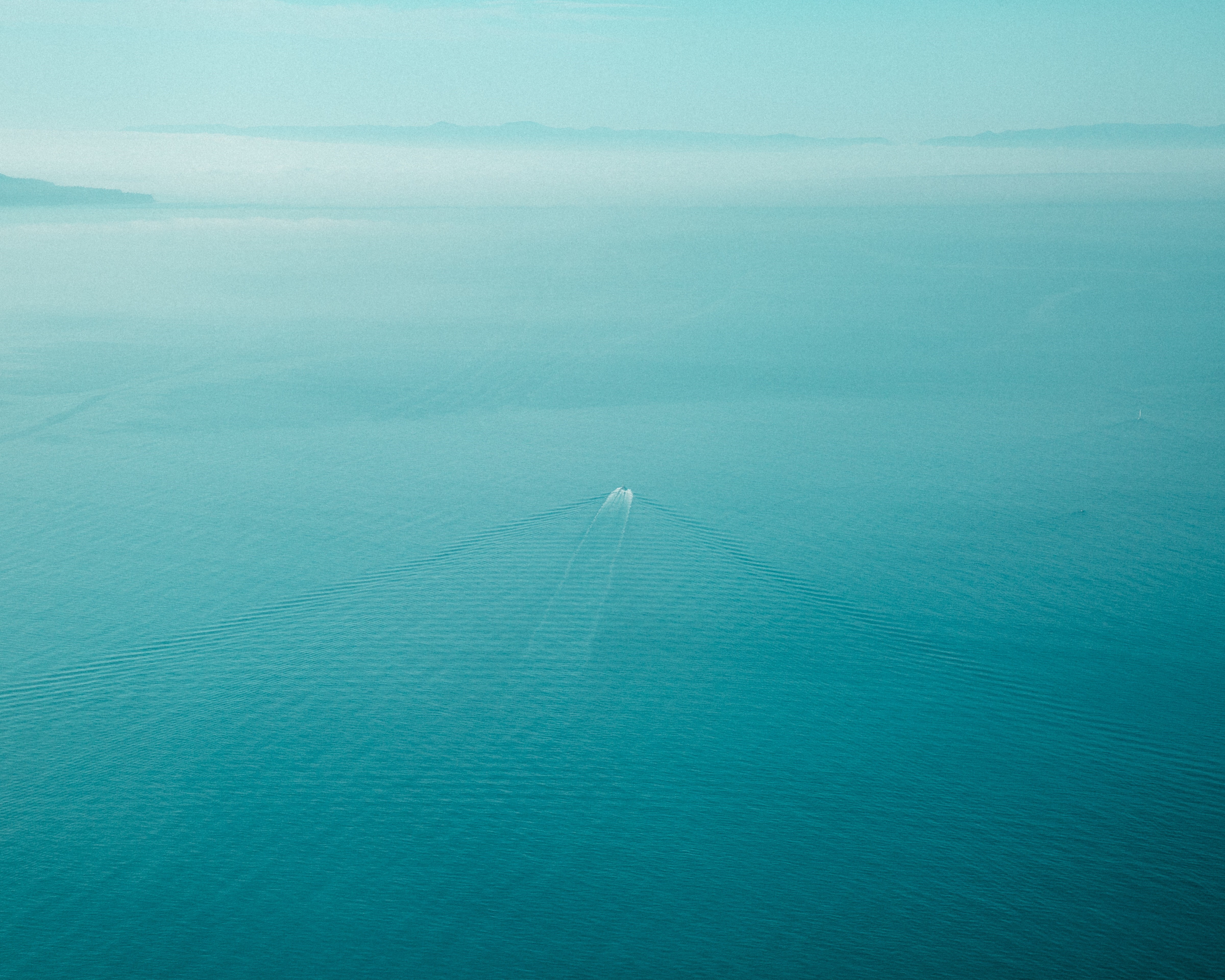 Boat on the water with fog in the distance HD Wallpaper