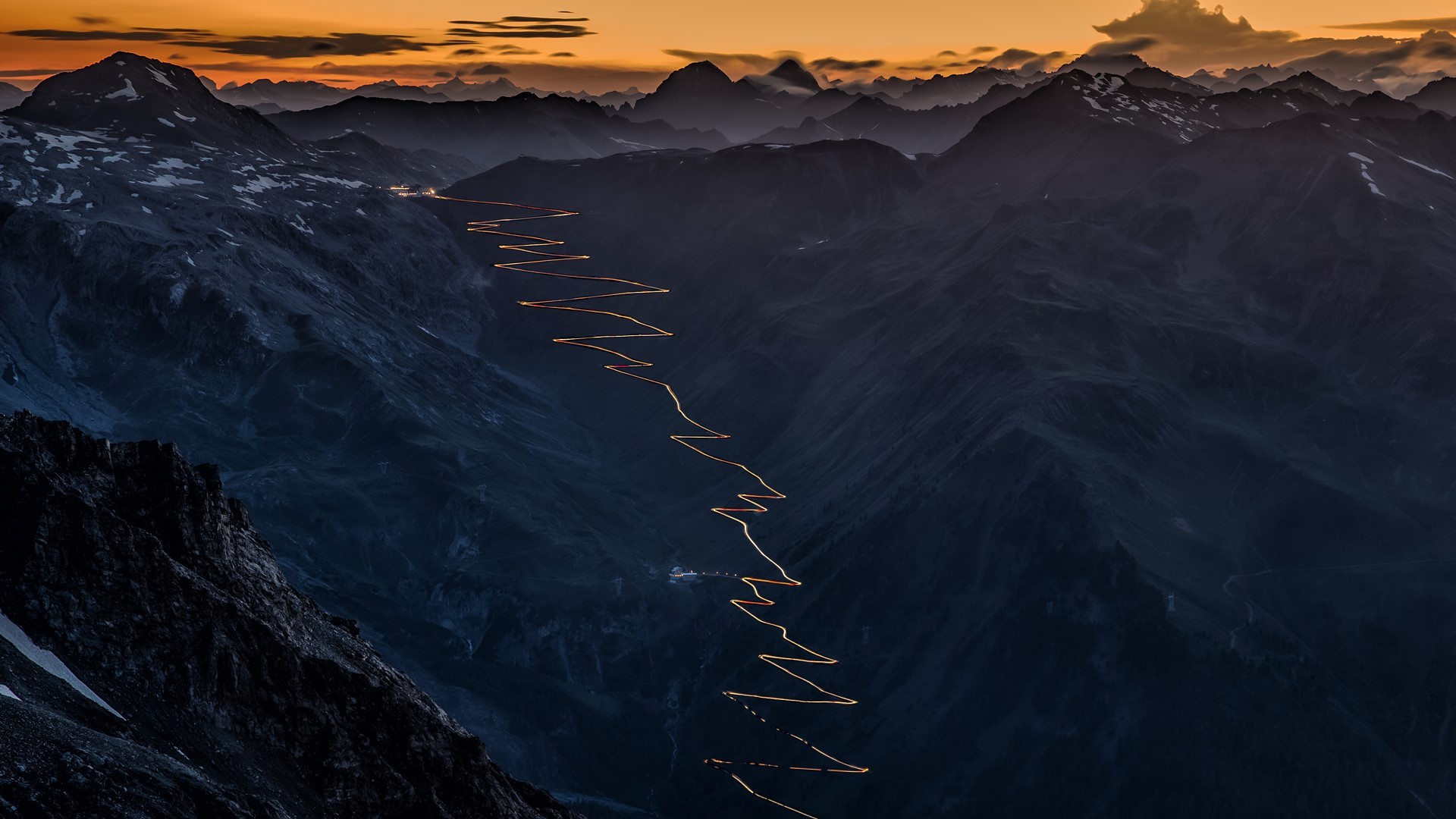 Stelvio Pass road with lights at sunset, Italy HD Wallpaper