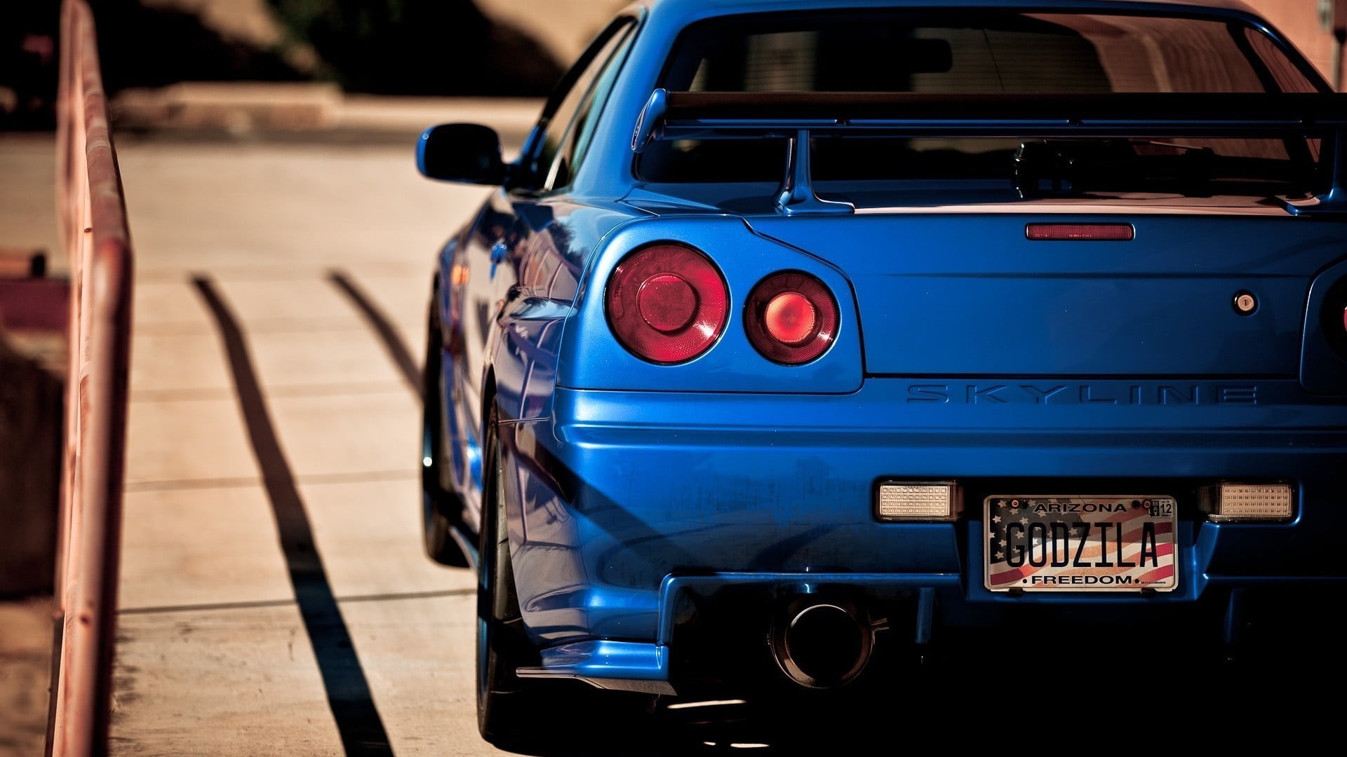 Blue Nissan Skyline GT-R R34 with Godzilla license plate HD Wallpaper