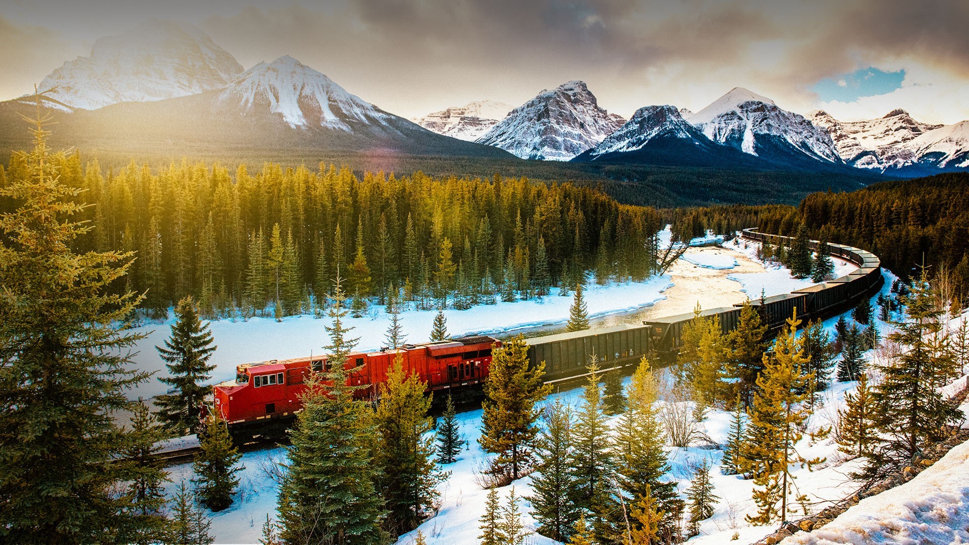 Red train in snowy Canadian Rockies landscape HD Wallpaper