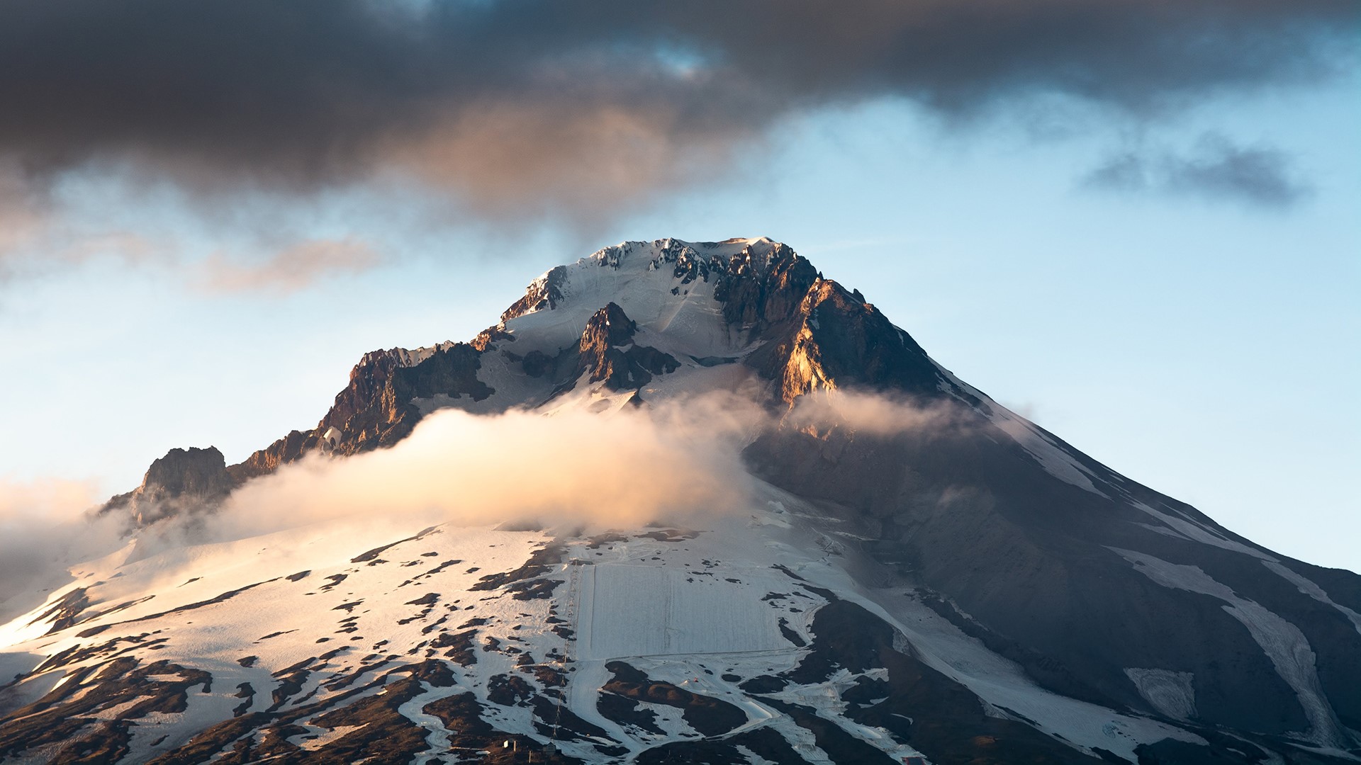 Snowy mountain peak with clouds at sunset HD Wallpaper