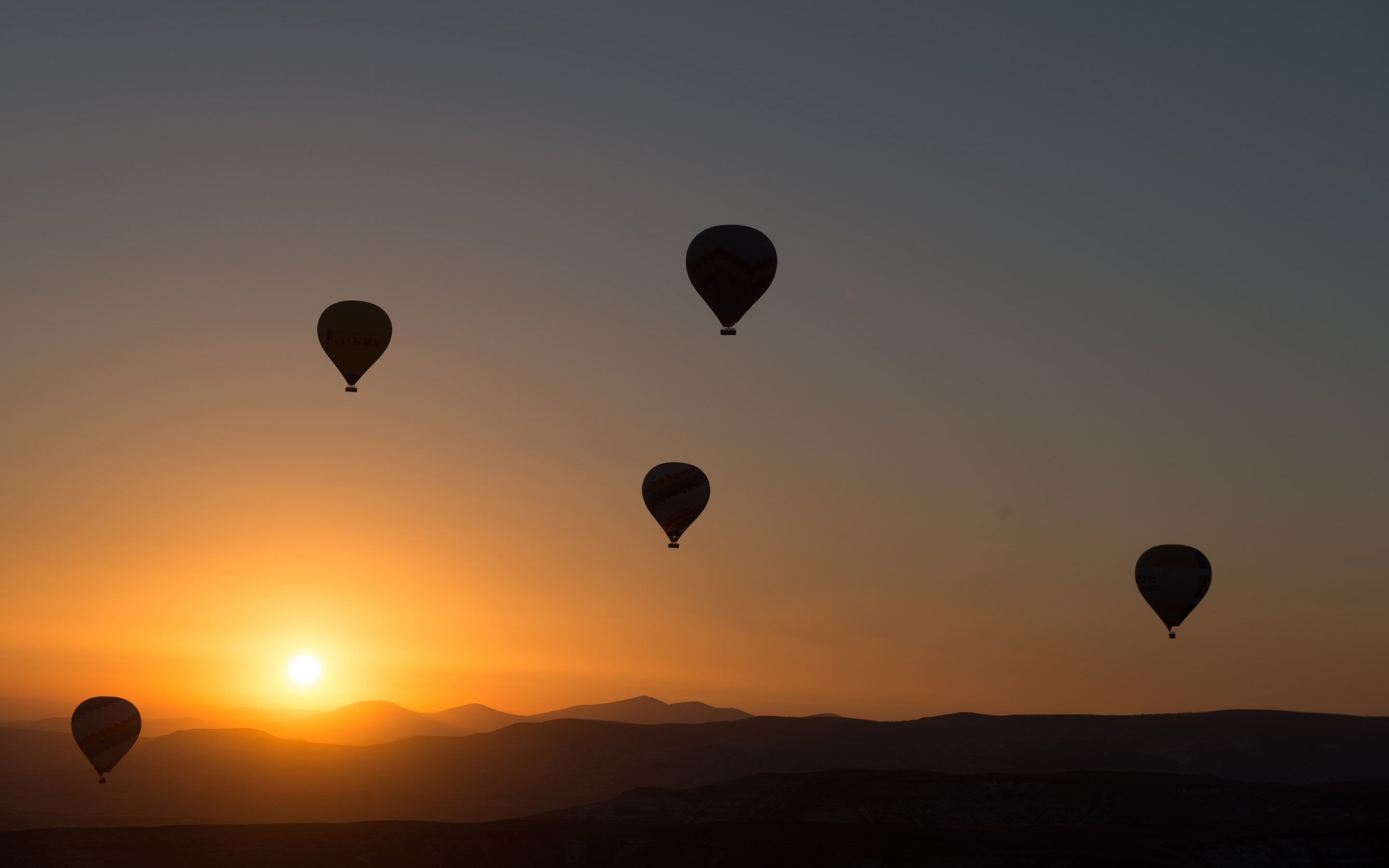 Hot air balloons at sunrise over mountains HD Wallpaper